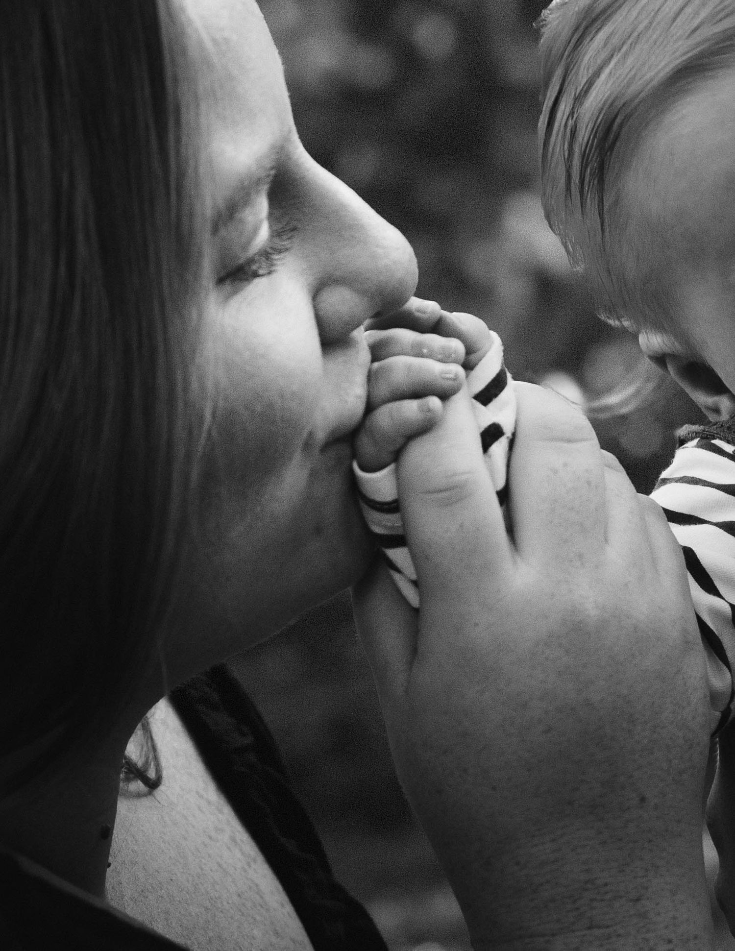 A series of black and white photographs showing two people engaged in an intimate kiss from different angles.