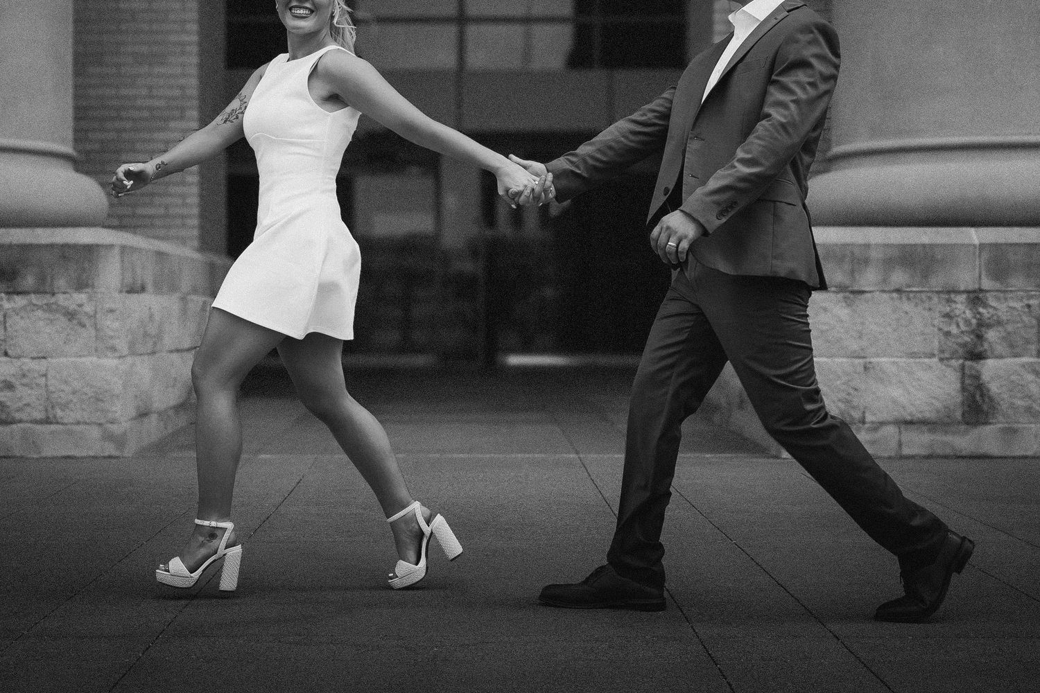 A dynamic sequence of feet in black and white shows traditional ballroom dancing steps with contrasting light and dark shoes.