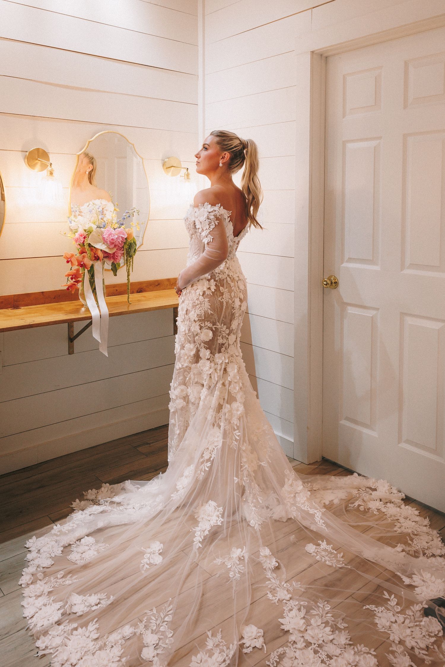 Close-up shots of an elegant lace wedding dress with a dramatic cathedral train displayed from multiple angles.