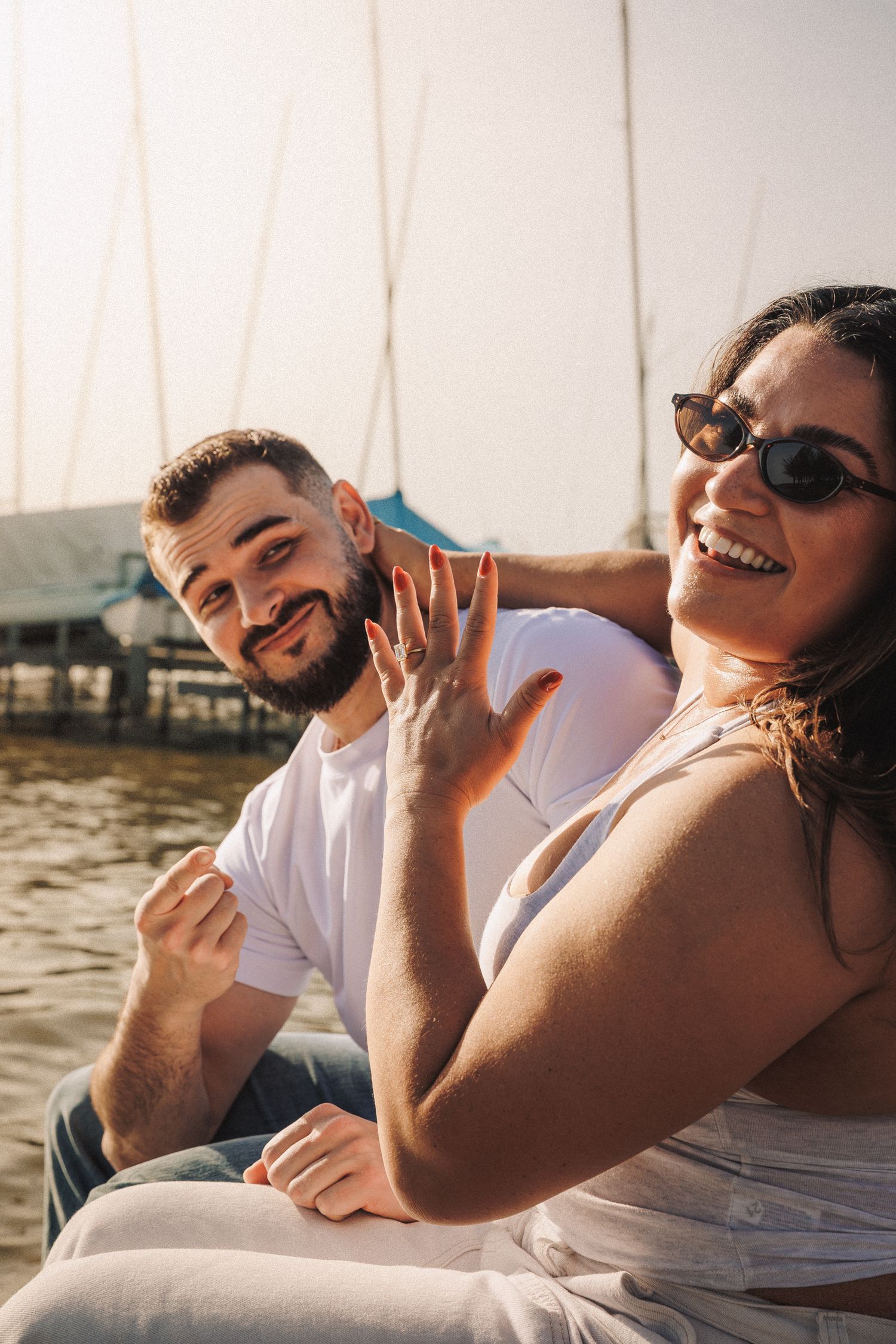 Candid moments of joy and laughter shared between a couple by the water.