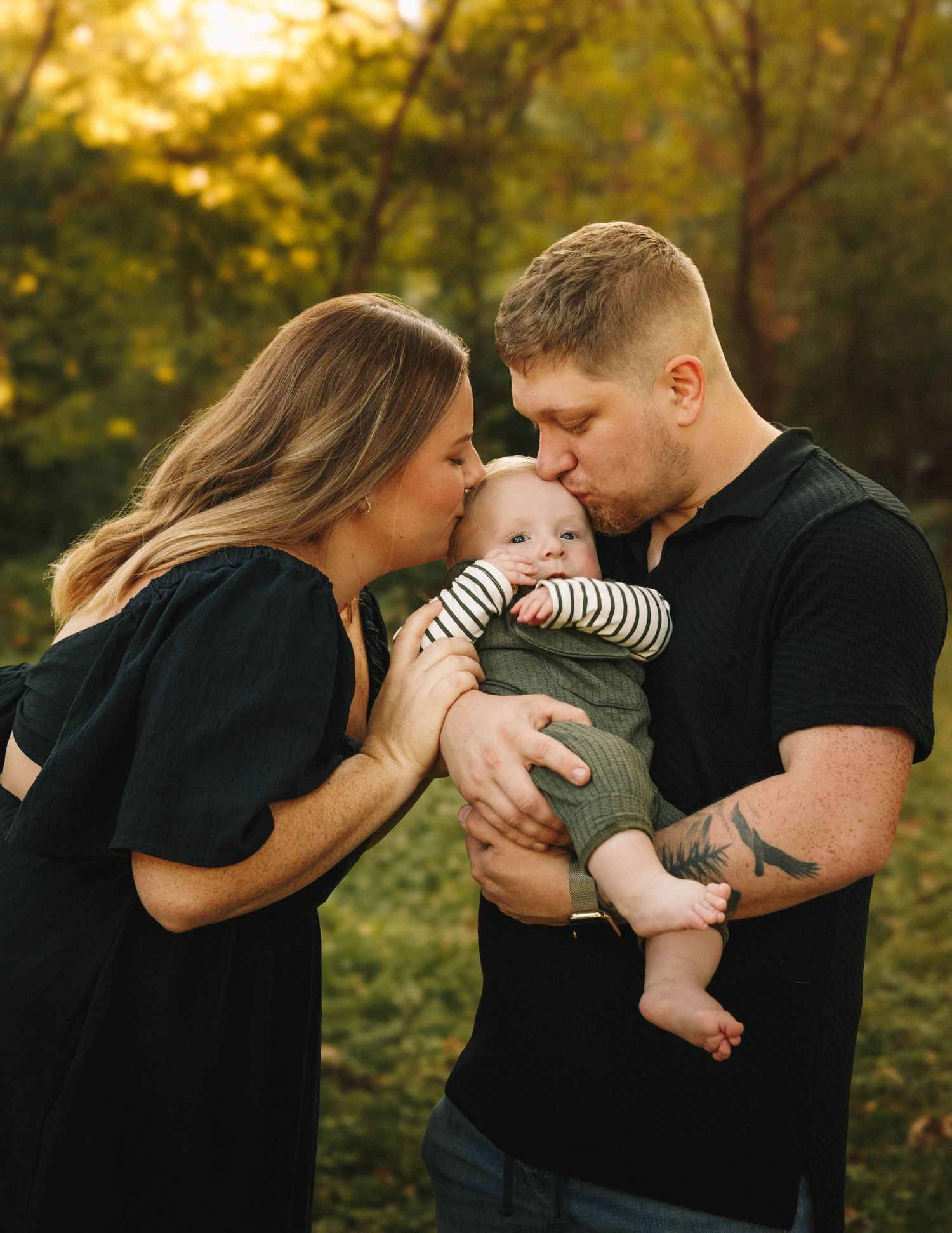 A family shares tender moments outdoors during golden hour in a series of intimate poses with their baby.