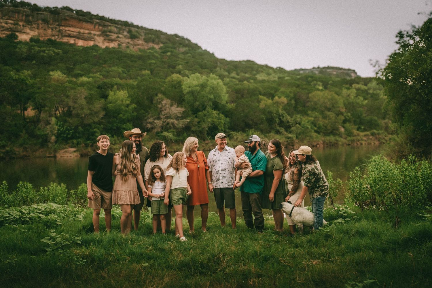 Seven panoramic views show a group of people gathered in outdoor settings with green hills in the background.