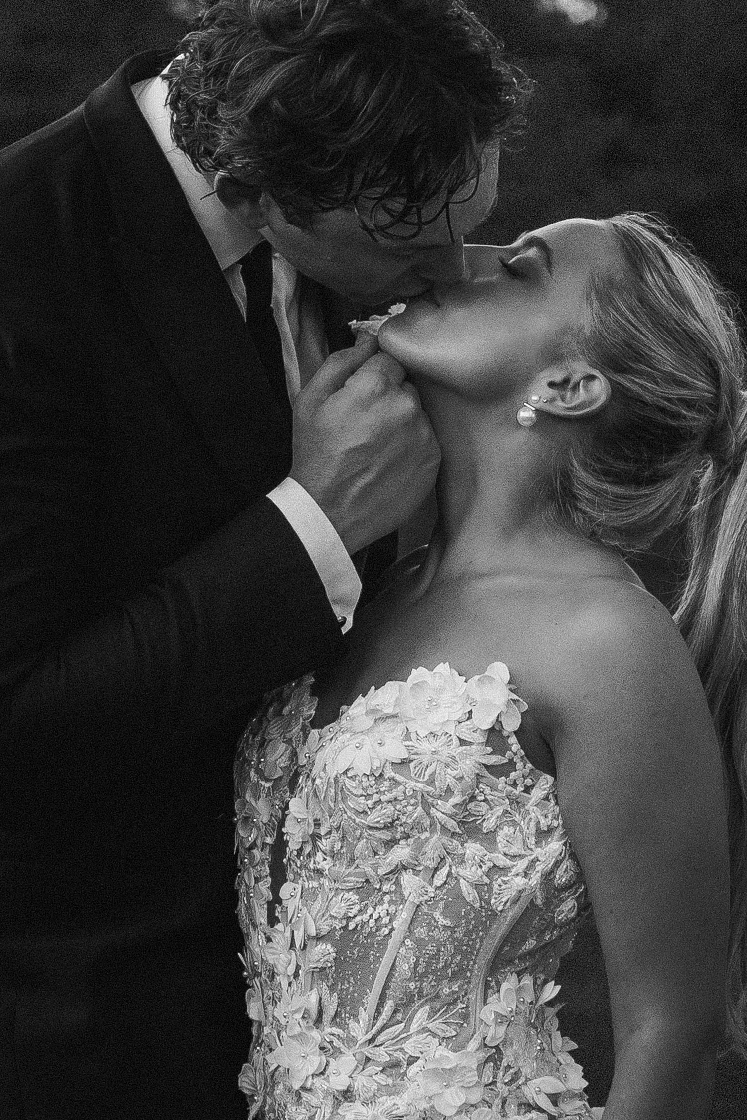 An intimate black and white portrait of a romantic moment between newlyweds.