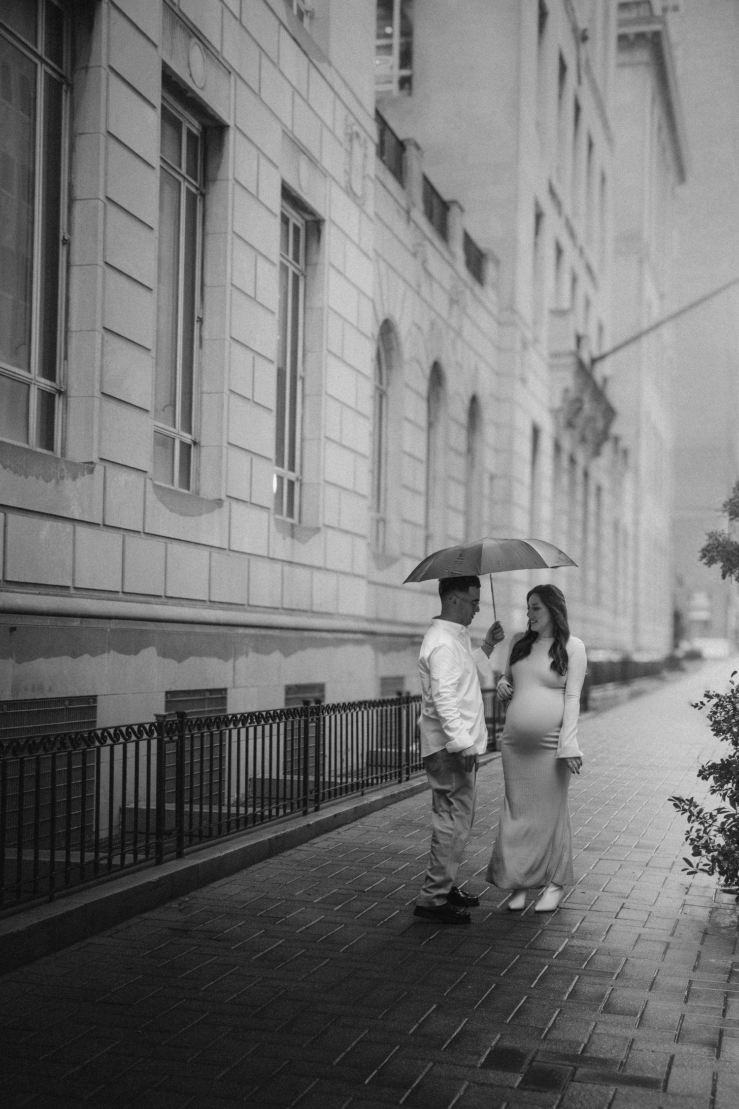 A sequence of black and white photos showing two people walking along a building corridor casting dramatic shadows on the wall.