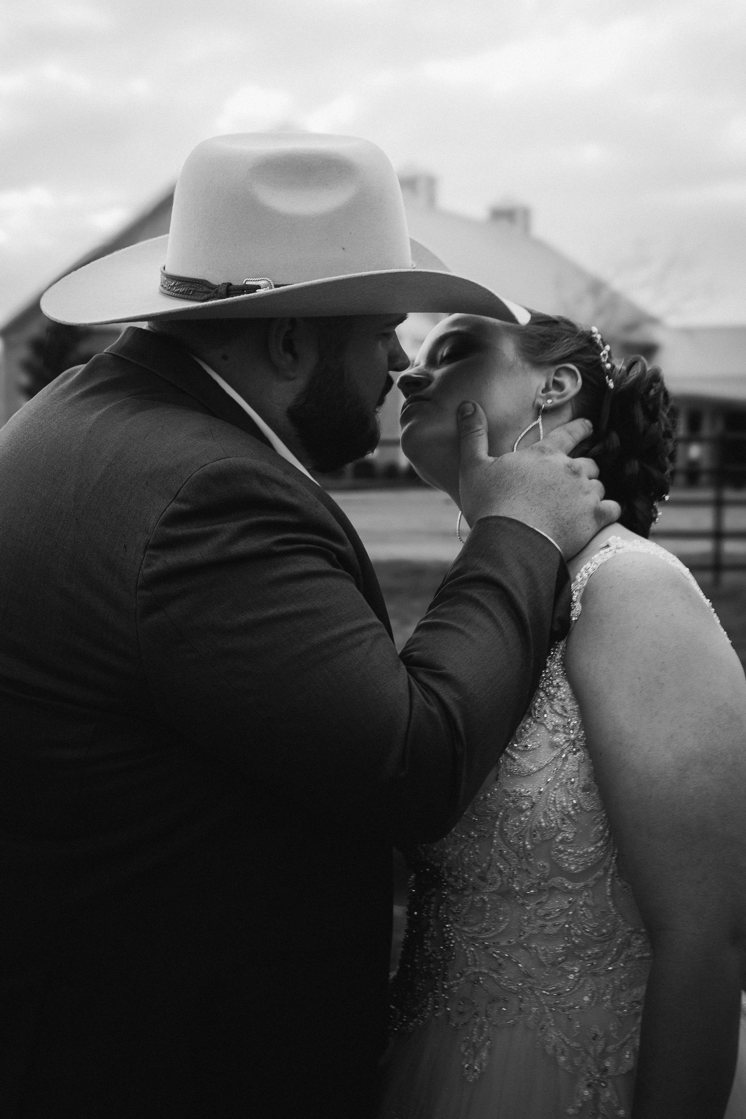 A romantic black and white photo sequence shows a couple in cowboy hats sharing a tender kiss outdoors.