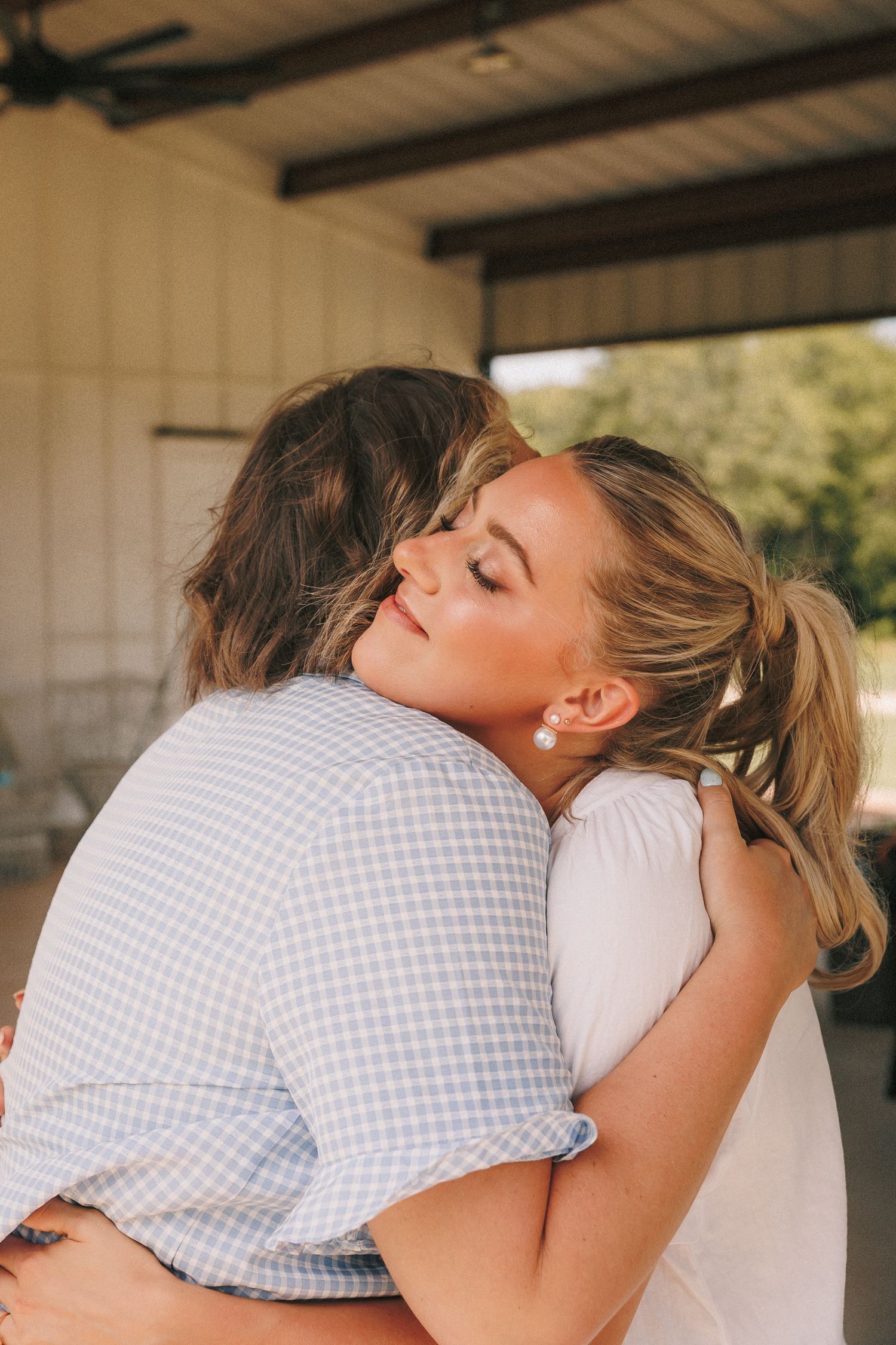 Two people sharing an emotional embrace during wedding celebrations.
