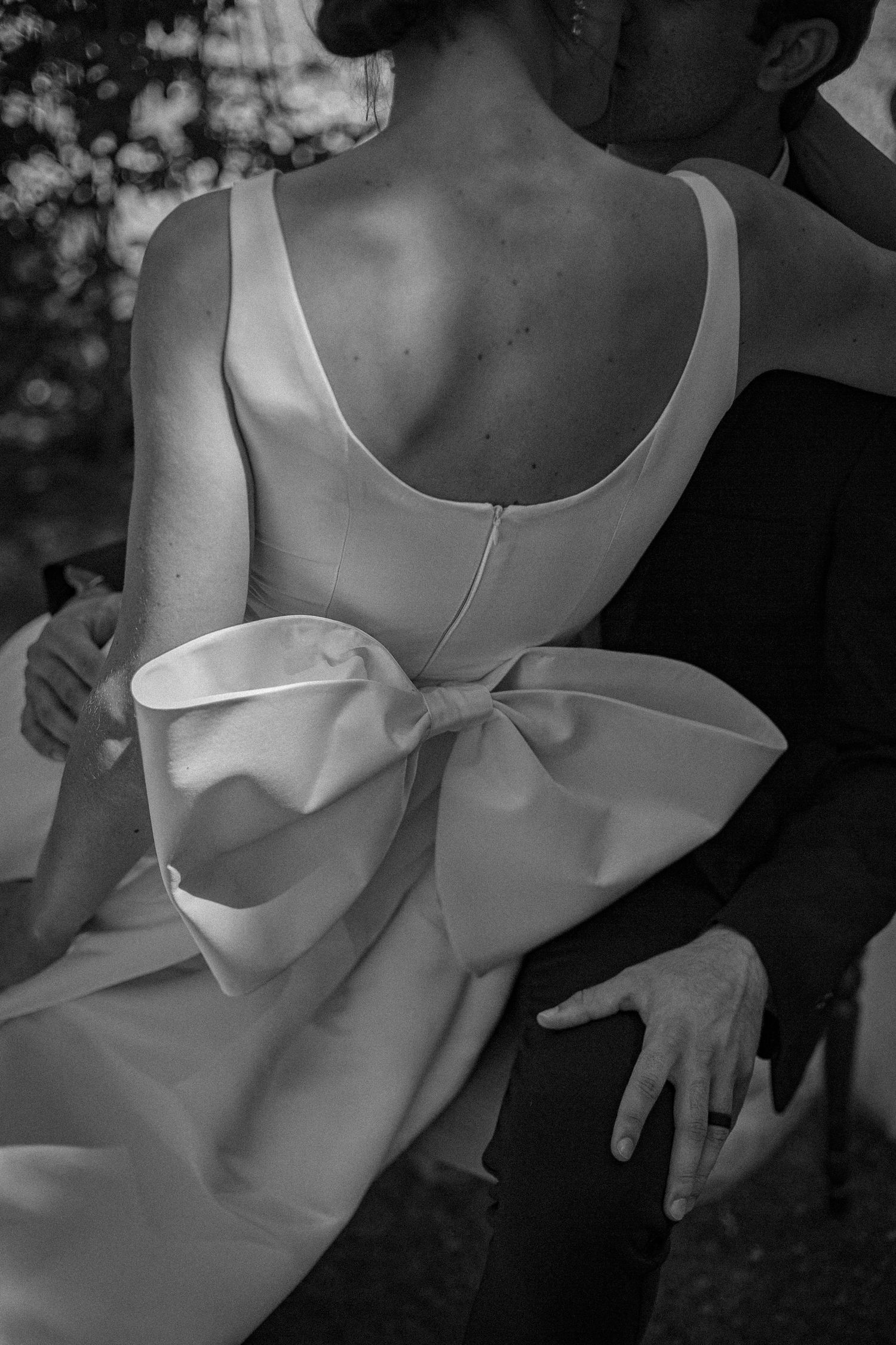 A elopement couple with a big bow on the dress