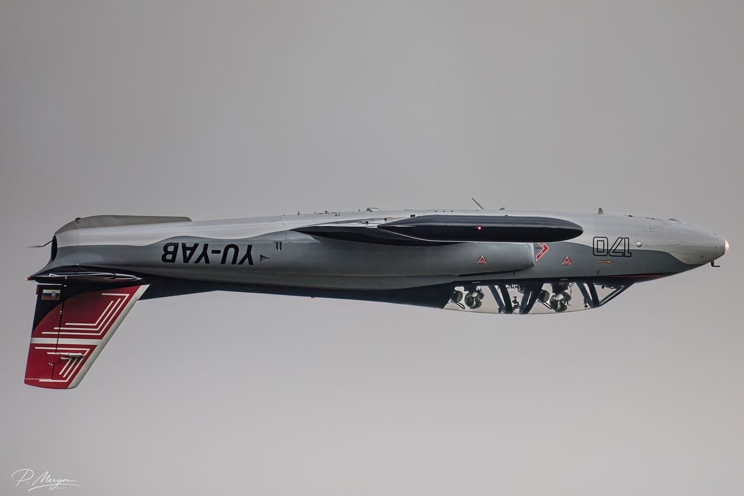 Serbian YU-YAB twin-boom vintage aircraft in level flight displaying underside at airshow.