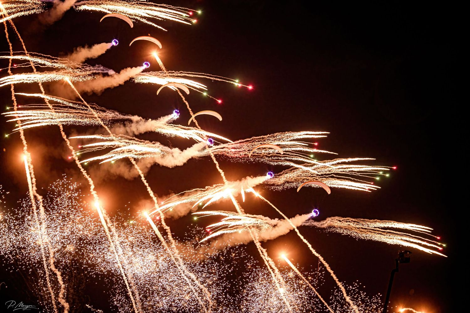 Spectacular golden fireworks cascade through the night sky in a stunning aerial pyrotechnic display.