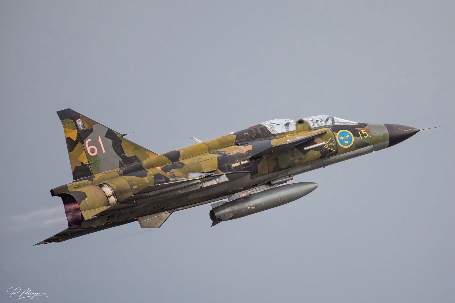 Saab Viggen fighter jet number 61 in camouflage livery performing a low pass at an airshow.