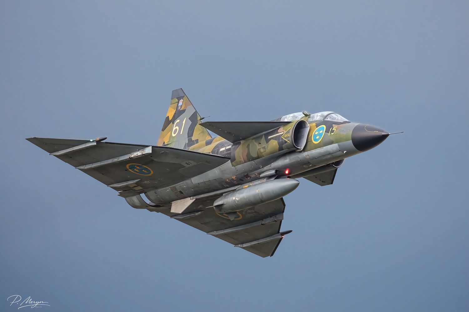 A Swedish Air Force Saab Draken delta-wing fighter jet performs a dynamic airshow maneuver.