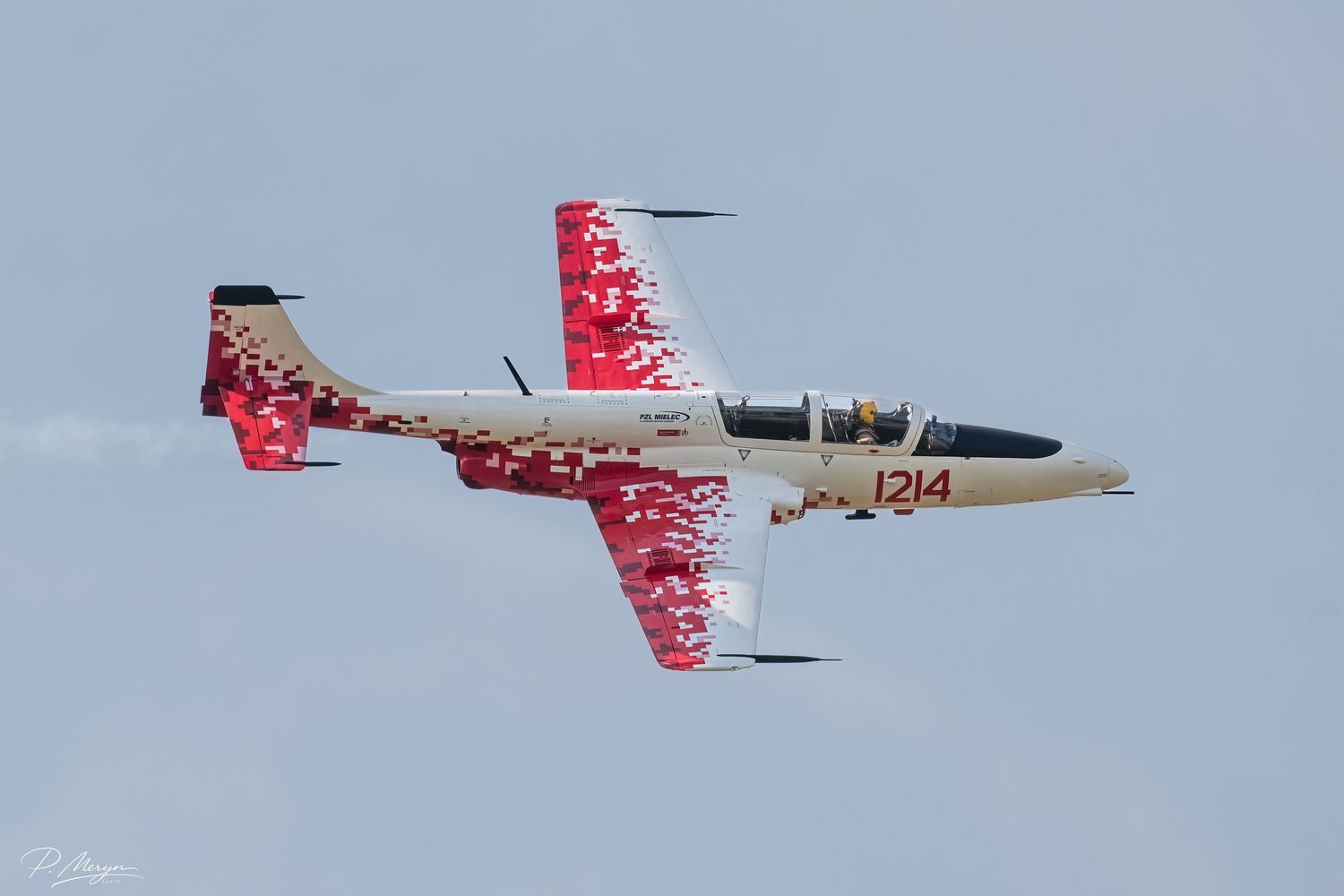 Polish Air Force L-39 Albatros jet trainer numbered 1214 in red and white livery performing airshow maneuver.