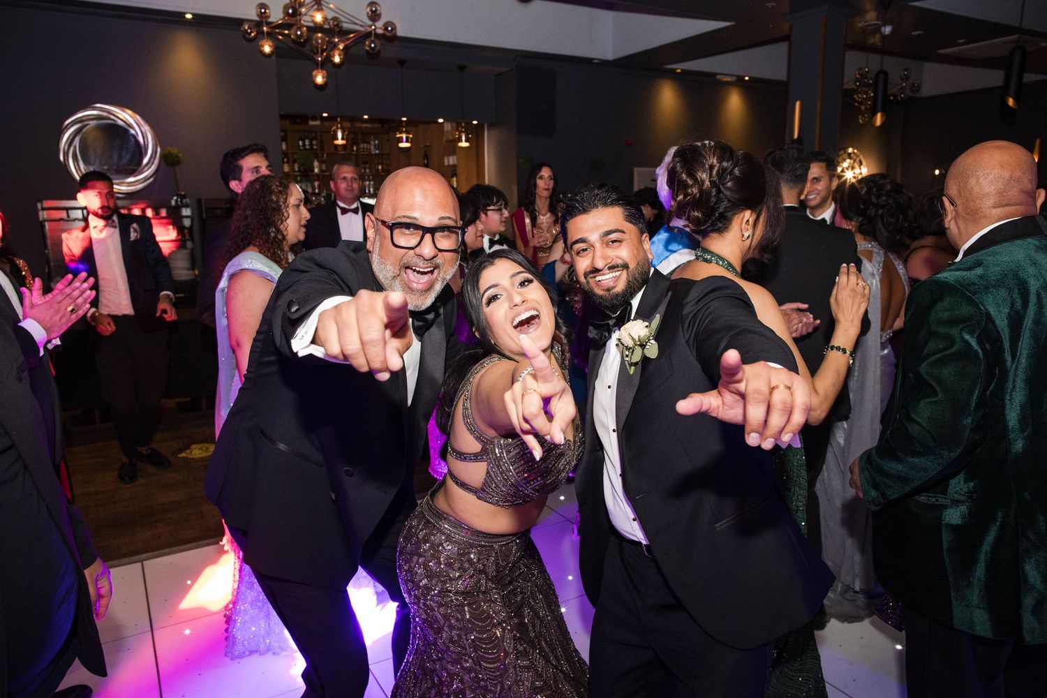 Wedding guests dancing and celebrating at the evening reception