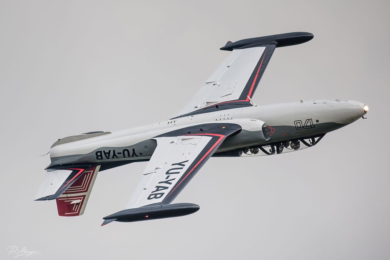 Vintage Yugoslav YU-YAB twin-boom aircraft performing inverted flight at airshow.
