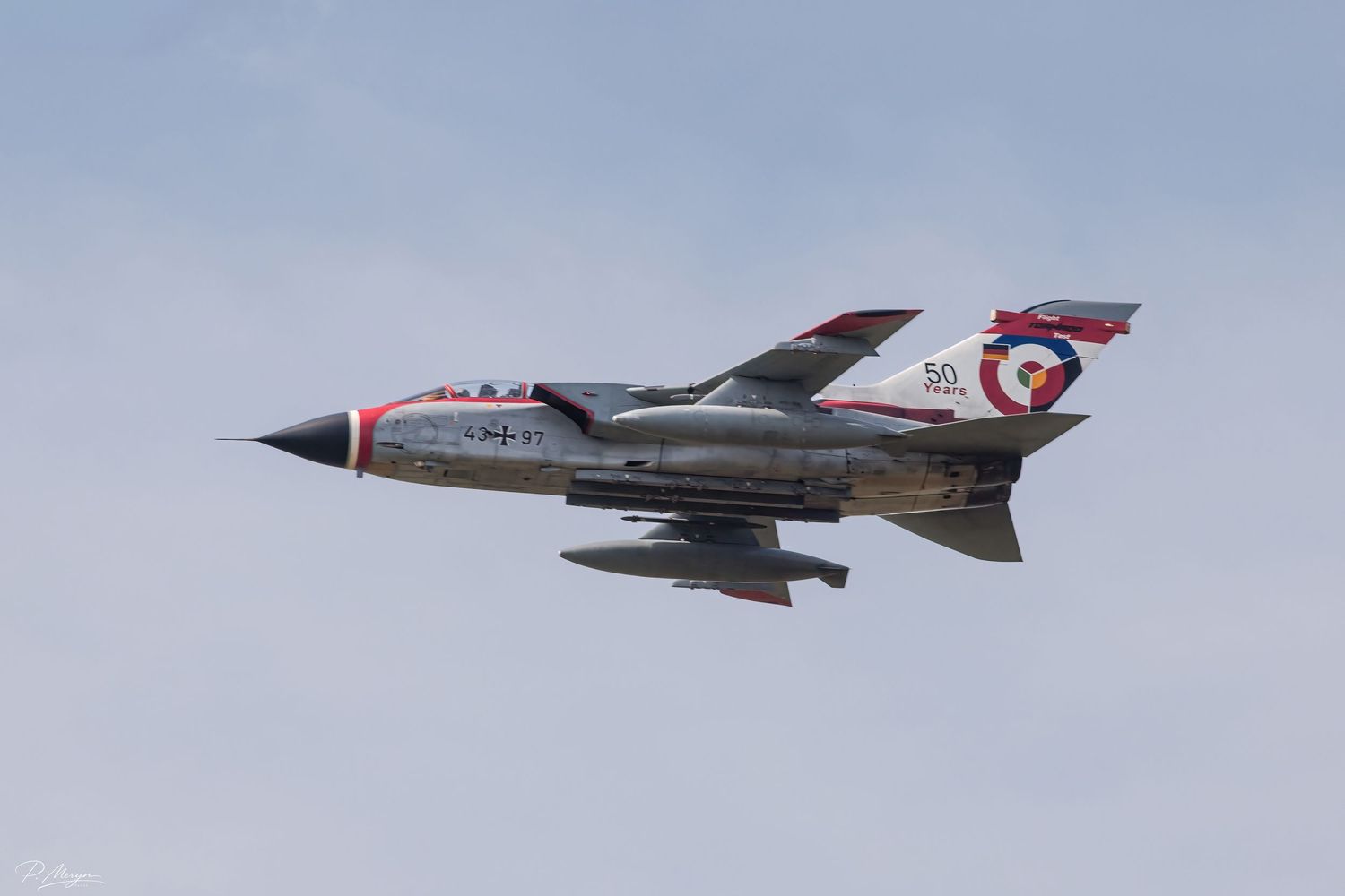 Panavia Tornado fighter jet in special anniversary livery performing a high-speed airshow pass.