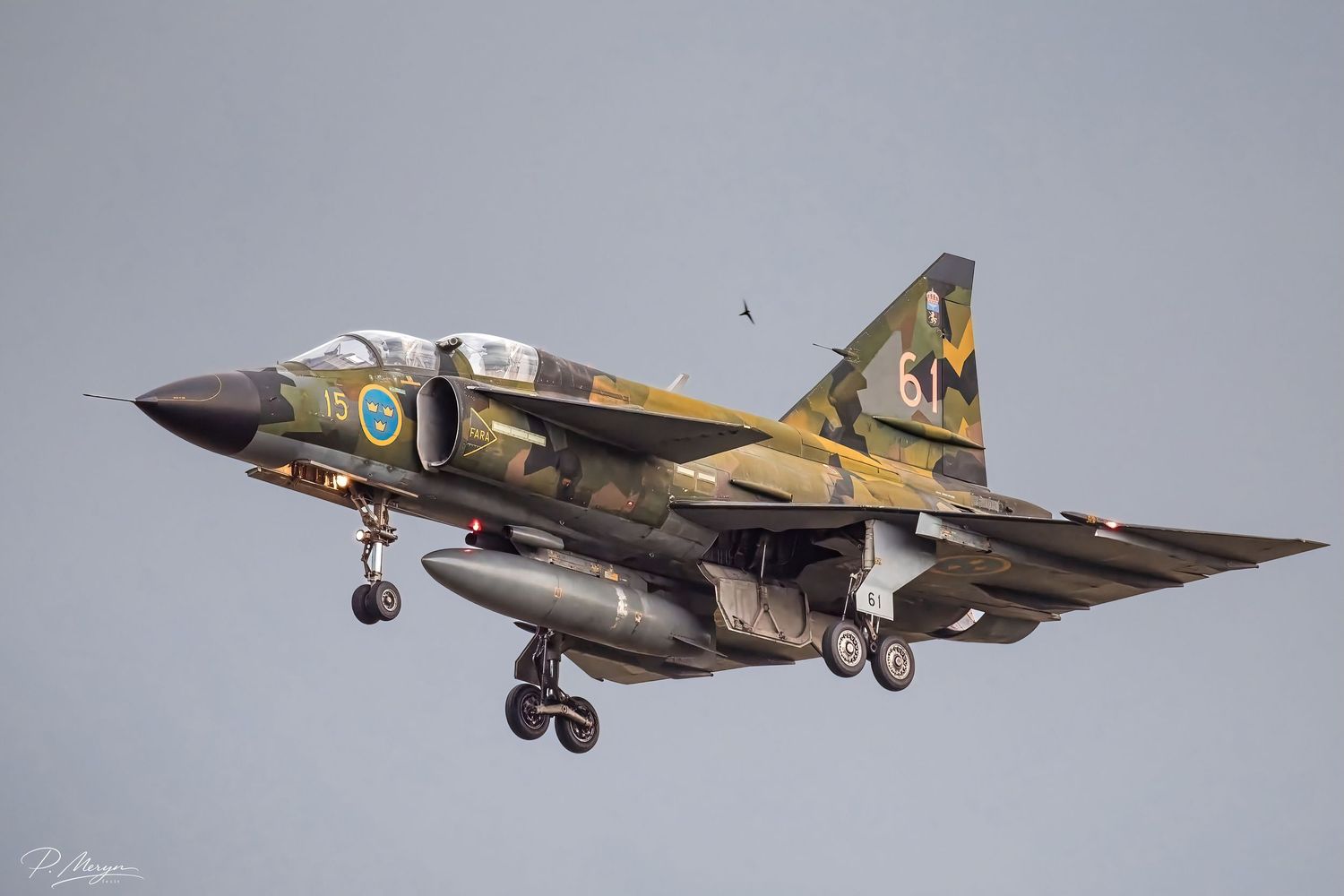 A Swedish Air Force Saab Viggen fighter jet in camouflage livery comes in for landing.