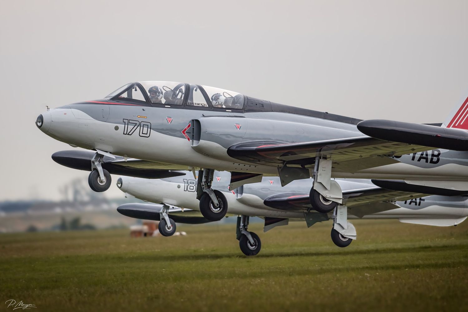 A vintage BAC Jet Provost military trainer aircraft with markings 170 and TAB taxiing on a grass airfield.