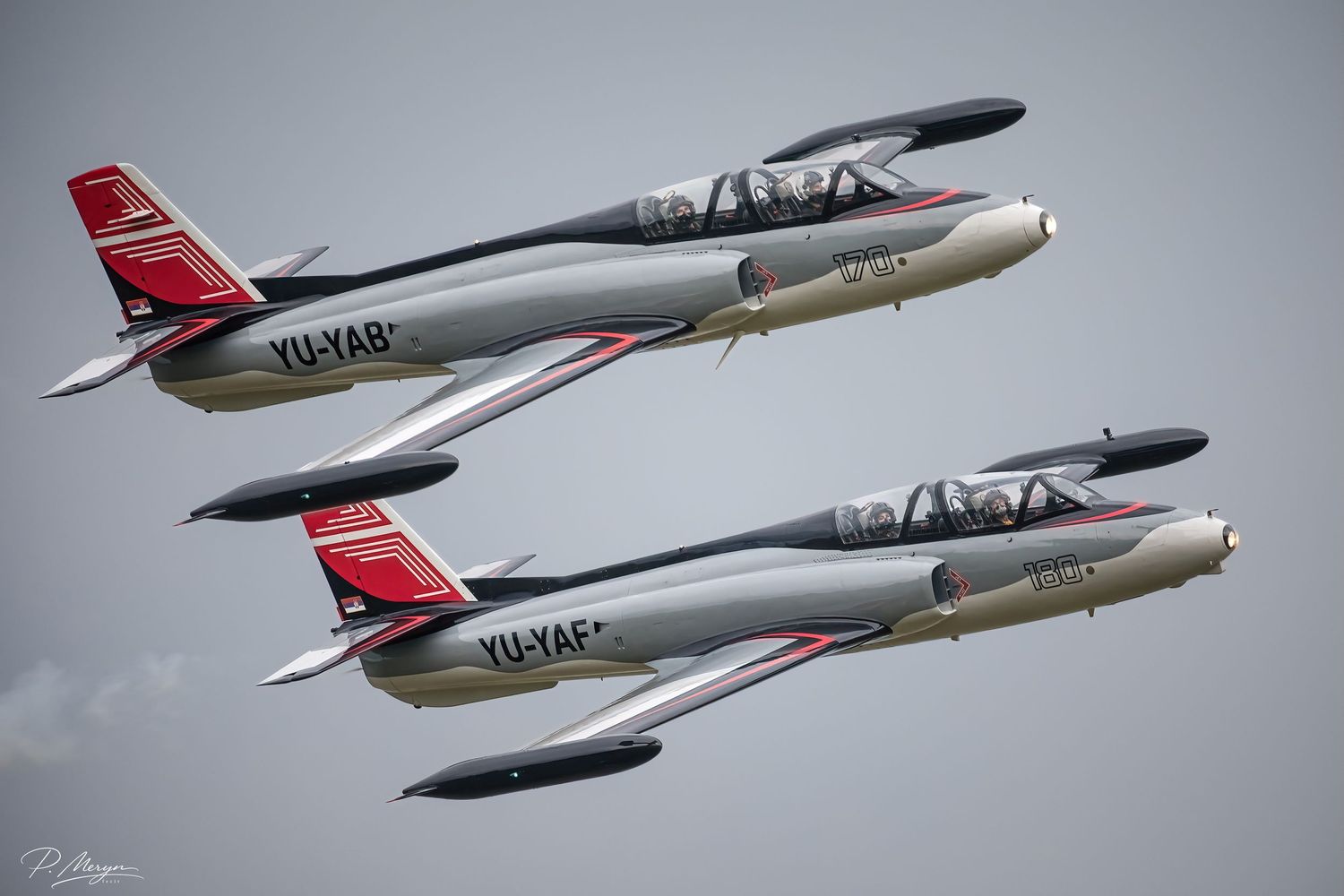 Two Serbian Air Force SOKO G-2 Galeb jets in close formation flight display.