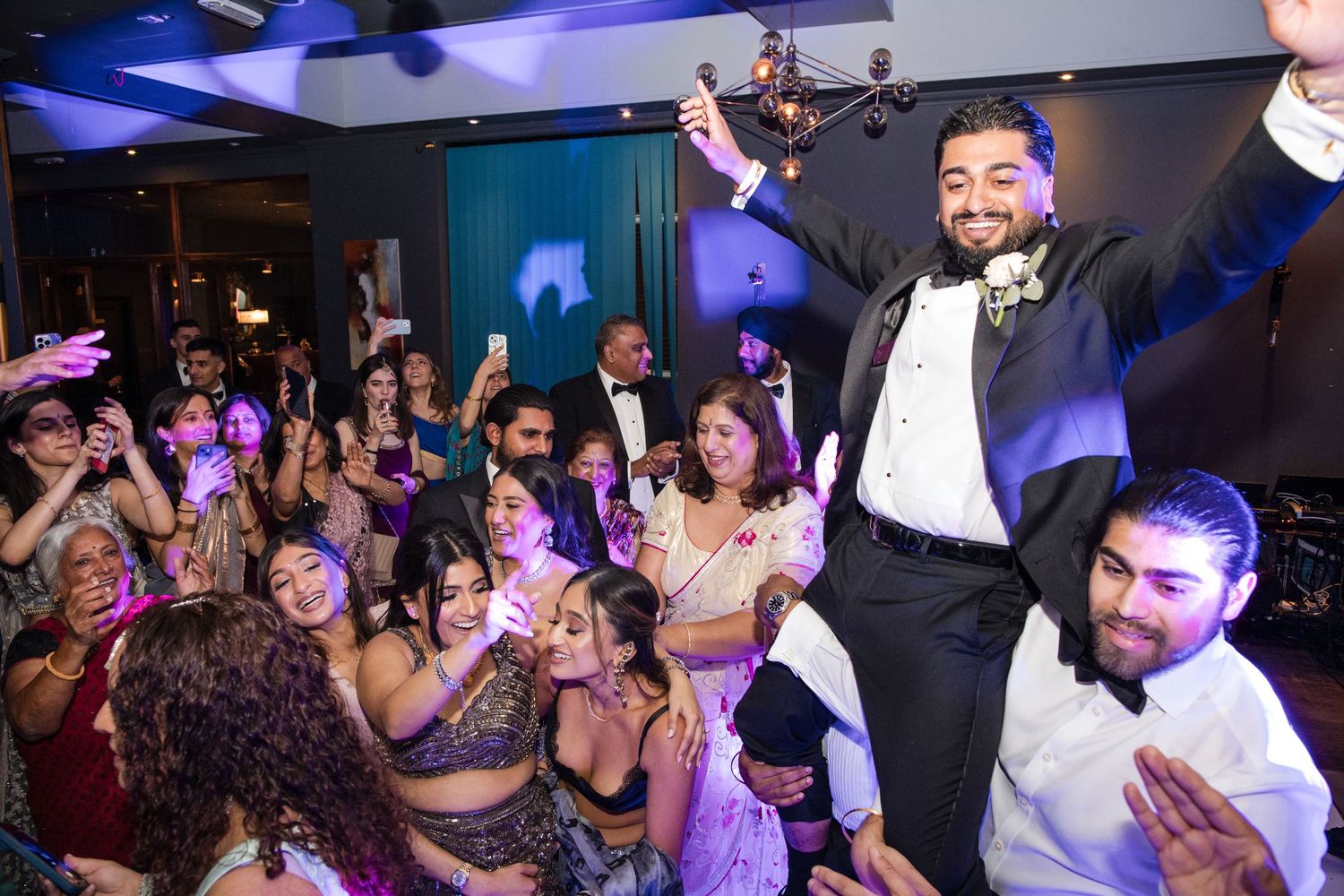 Groom celebrating on the dance floor during the wedding reception
