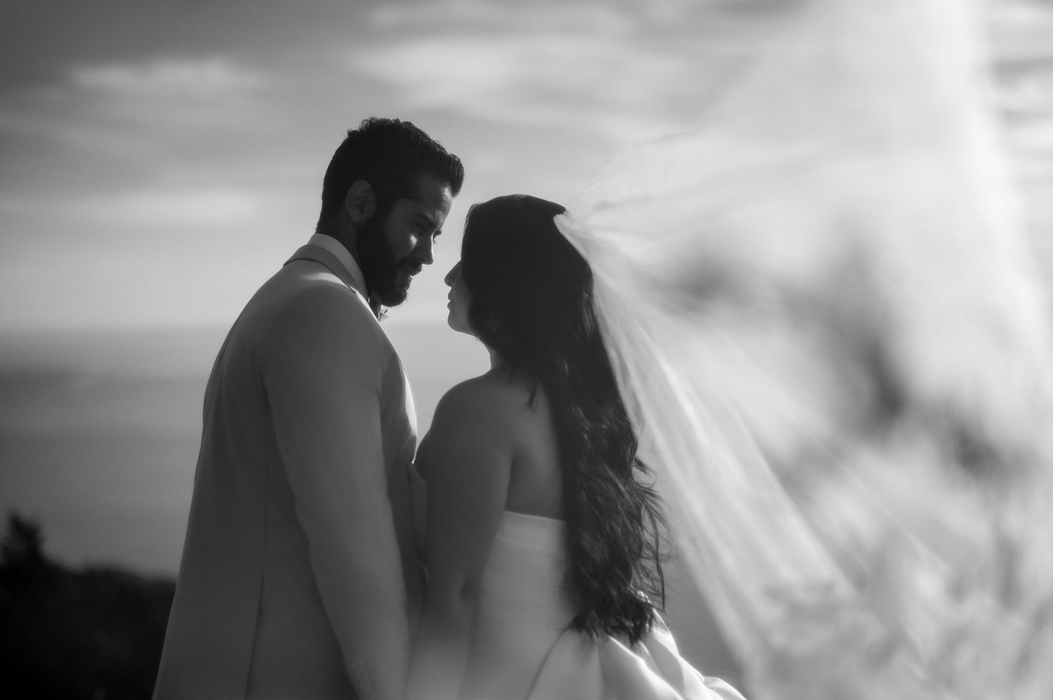 Bride and groom with flowing veil at Mount Tamalpais overlook, destination Northern California wedding photography by The Padillas