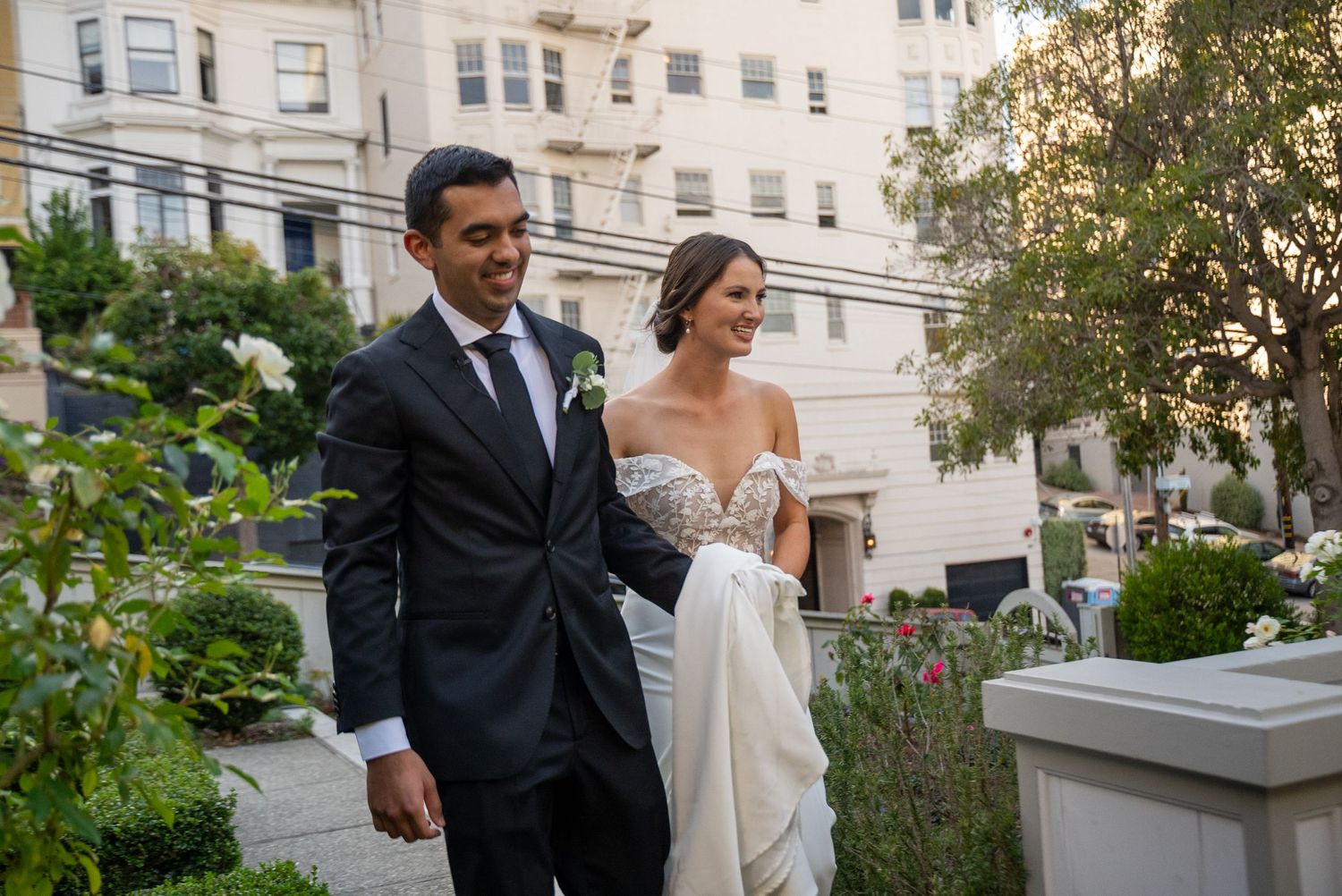 Bride and groom walking together after ceremony in San Francisco, candid wedding moments by The Padillas.