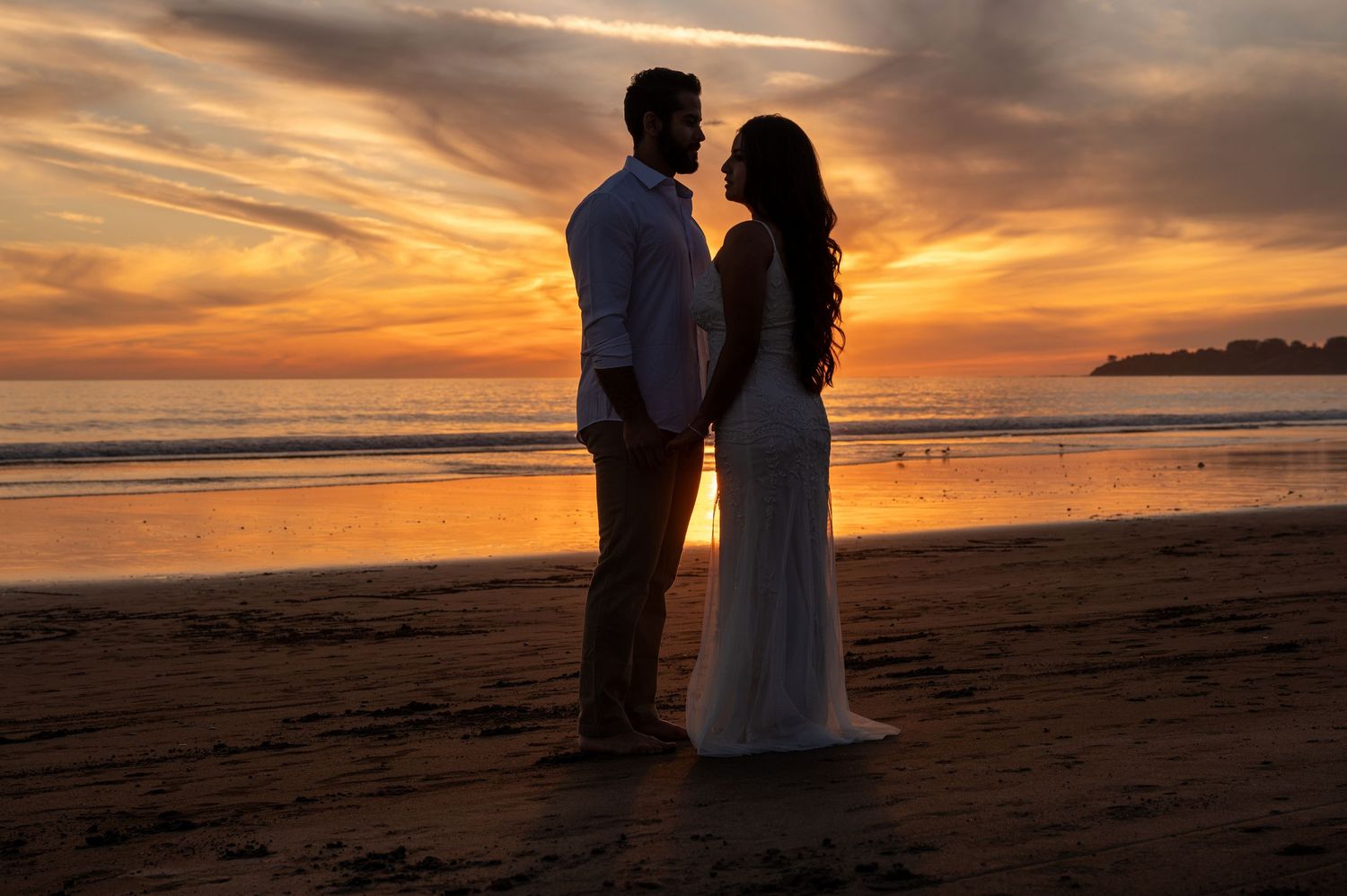 Bride and groom silhouetted at sunset on Stinson Beach, romantic Northern California coastal elopement photography by The Padillas