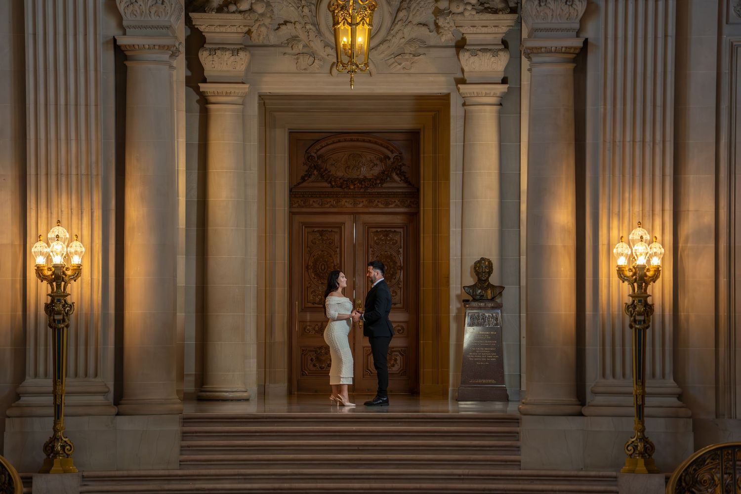 Bride and groom exchanging vows at San Francisco City Hall doorway, luxury intimate elopement photography by The Padillas