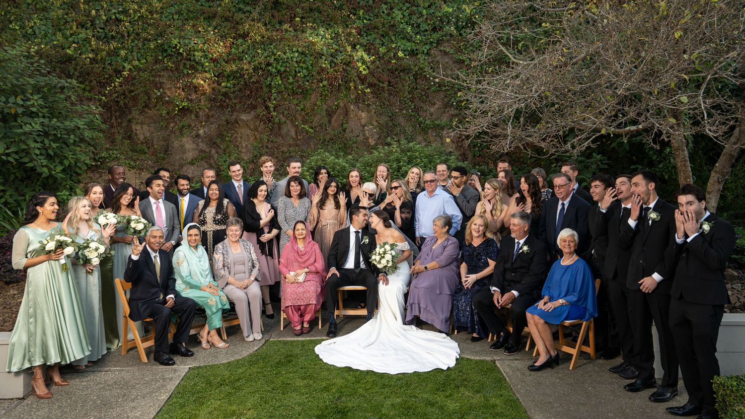 Full family wedding portrait outdoors in Fey Park San Francisco, natural light group photo by The Padillas Wedding Photographers.