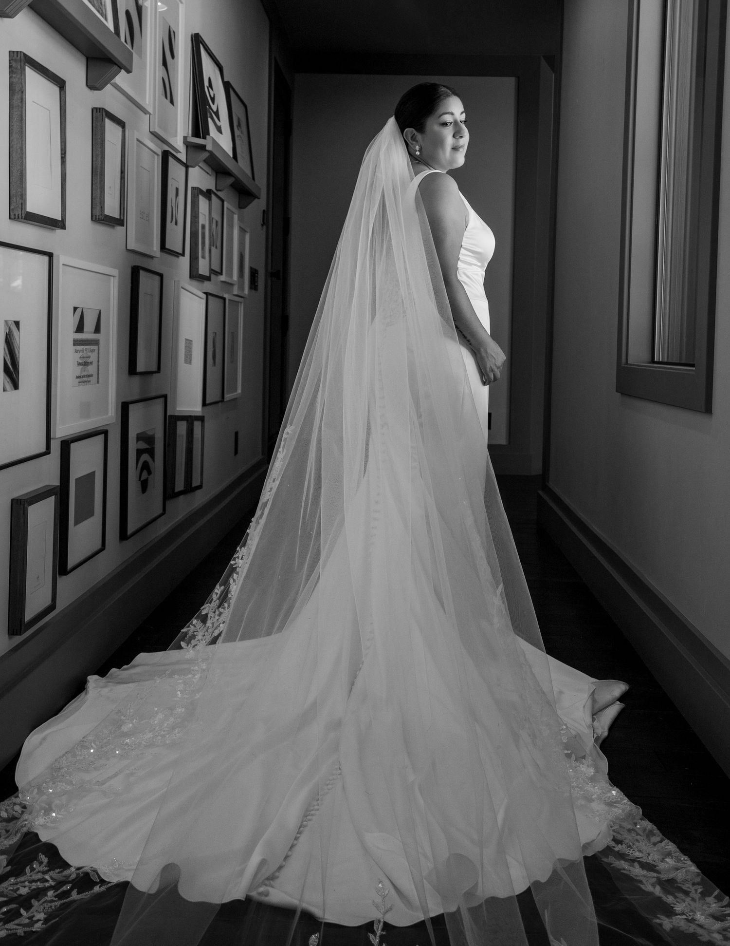 Elegant bridal portrait in hallway with long veil flowing at The Ranch at Lone Oak, wedding photography by The Padillas.
