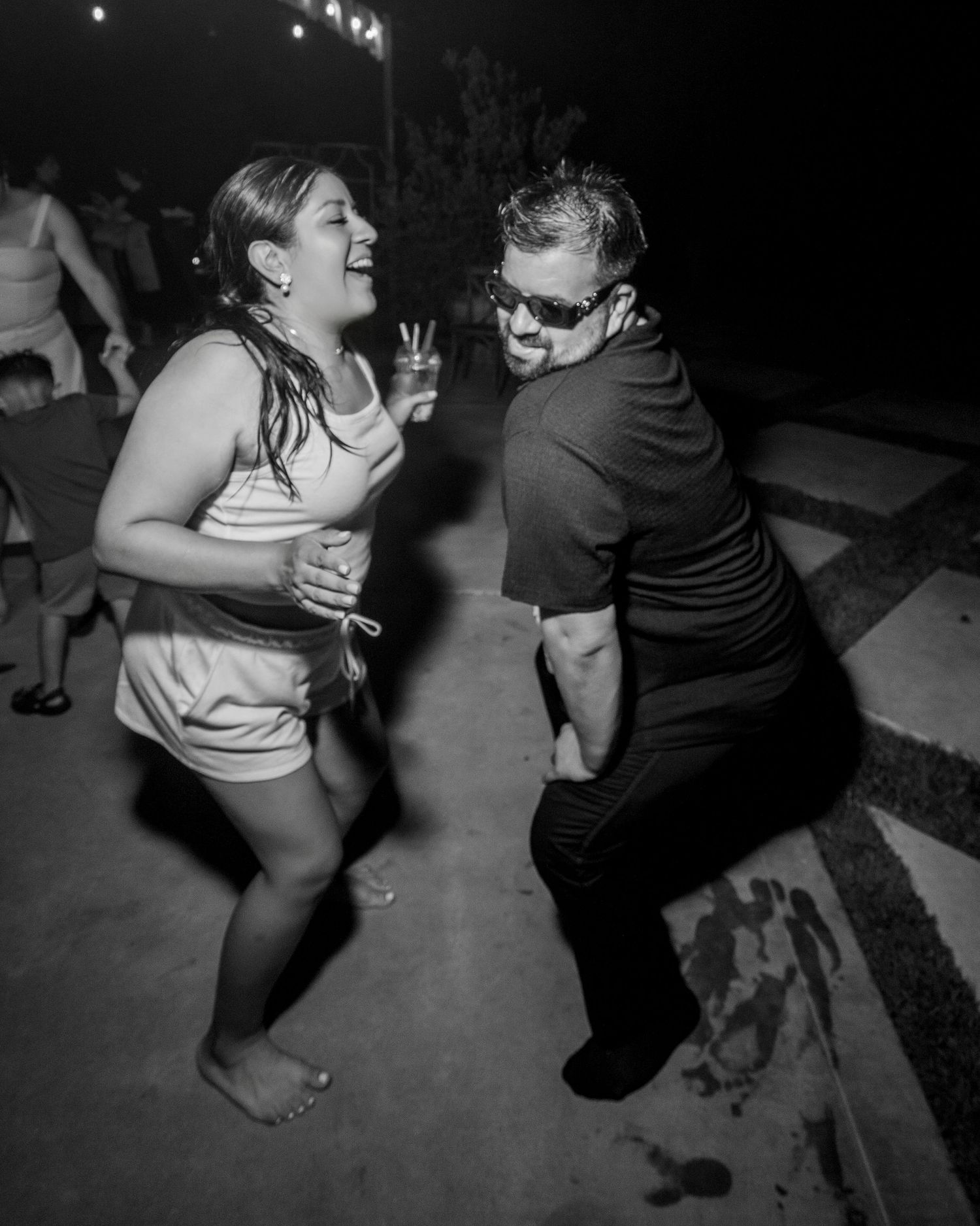Bride and groom dancing and laughing at night reception party, candid documentary style by The Padillas at The Ranch at Lone Oak.