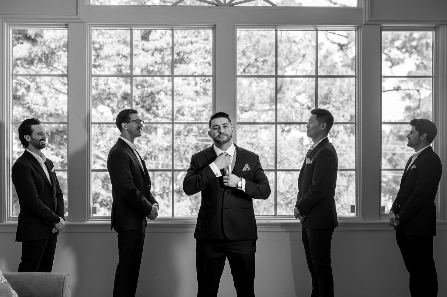 Candid moment of groom getting ready for wedding in Monterey captured by The Padillas documentary photographers.