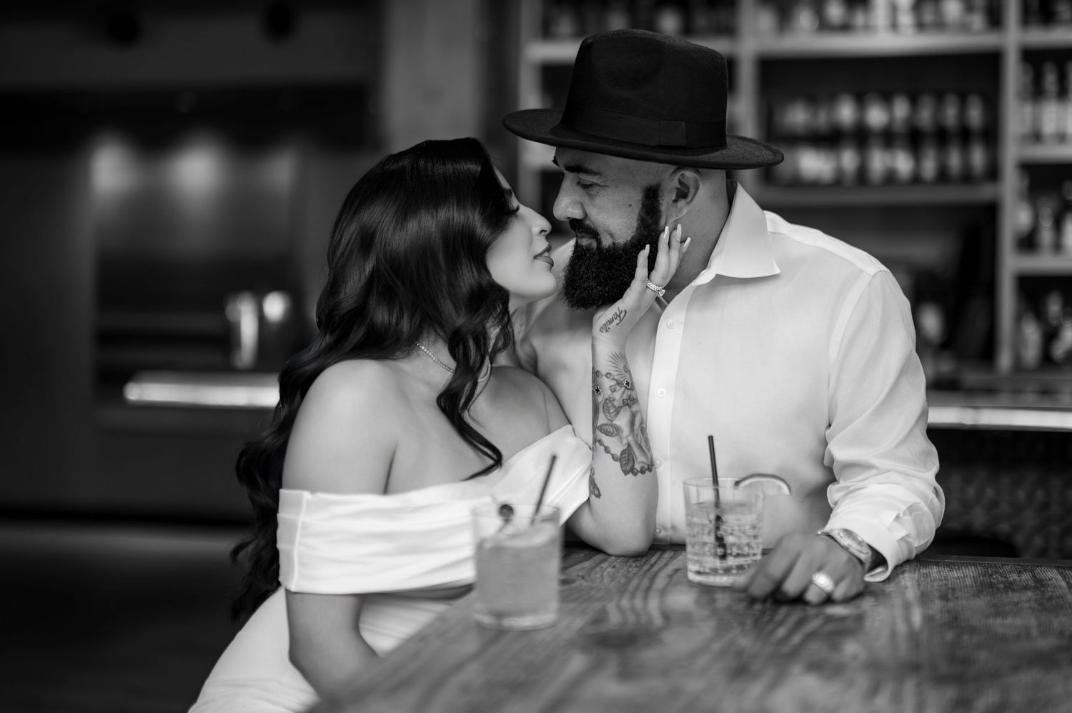 Engaged couple sharing drinks during downtown Sacramento engagement session, modern editorial pre-wedding photography by The Padillas
