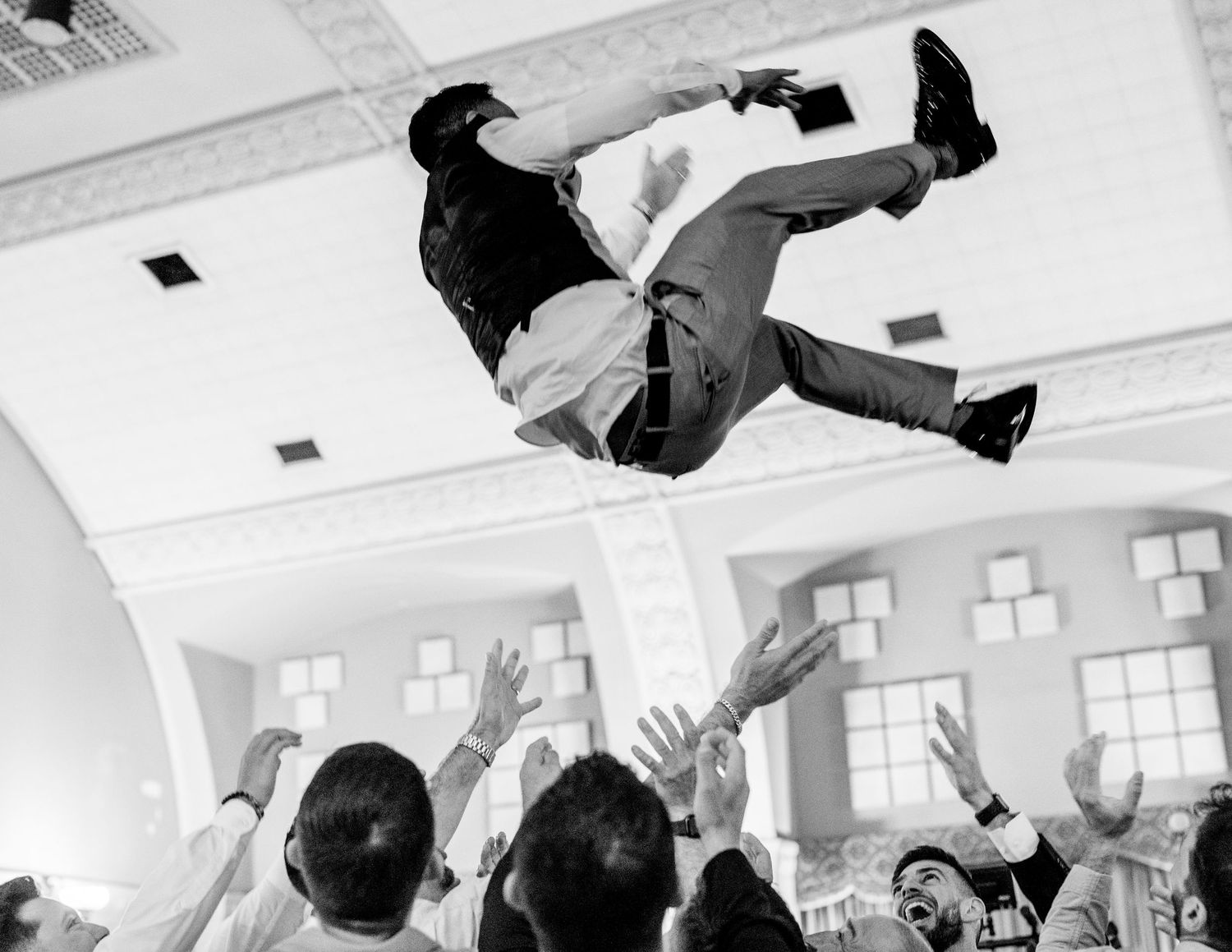 Groom tossed in air during wedding reception at Sacramento Masonic Temple, Mexican wedding celebration by The Padillas.