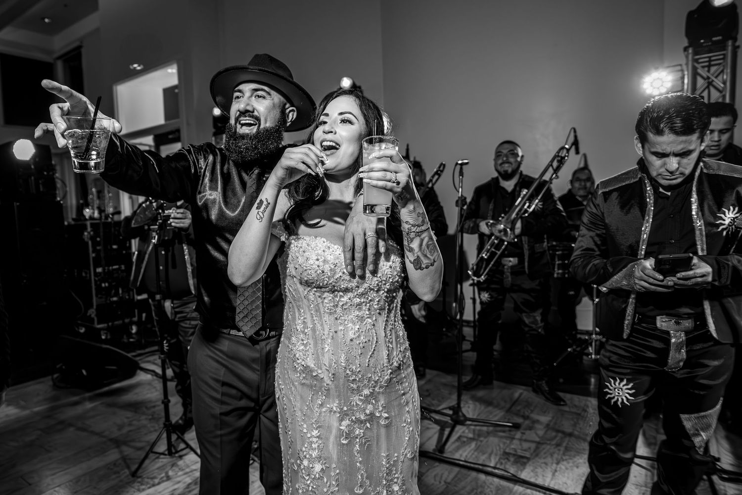 Bride and groom celebrating with mariachi band at Wedgewood Weddings Roseville reception, candid party photo by The Padillas Sacramento