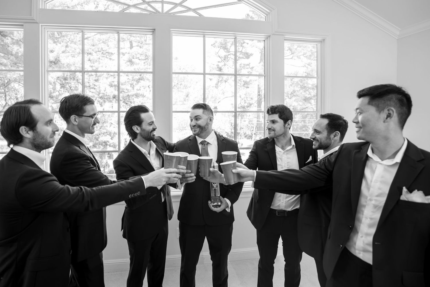 Groom and groomsmen wedding toast candid indoor photo Monterey wedding