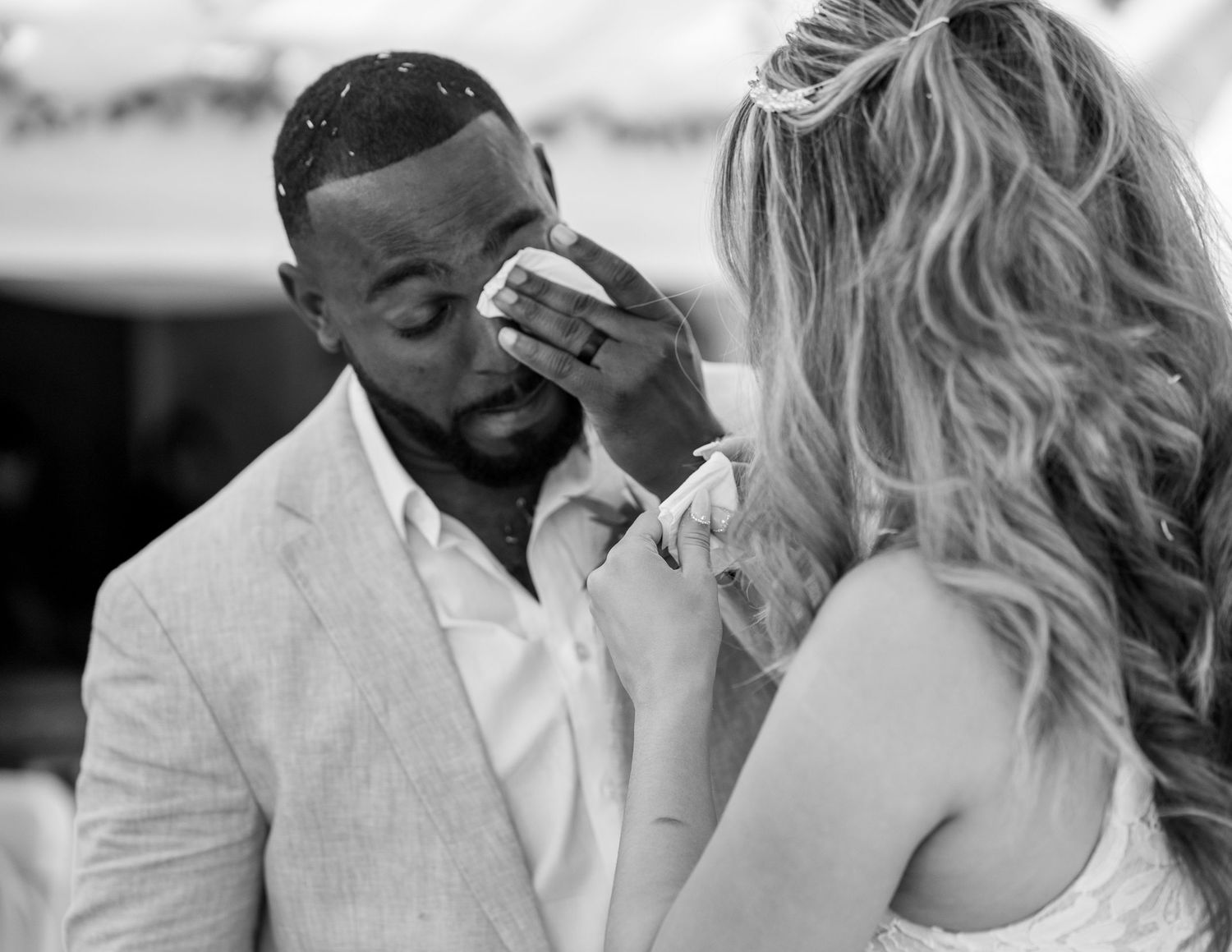 Wiping groom’s tears during emotional Sacramento wedding ceremony, documentary wedding photography by The Padillas.