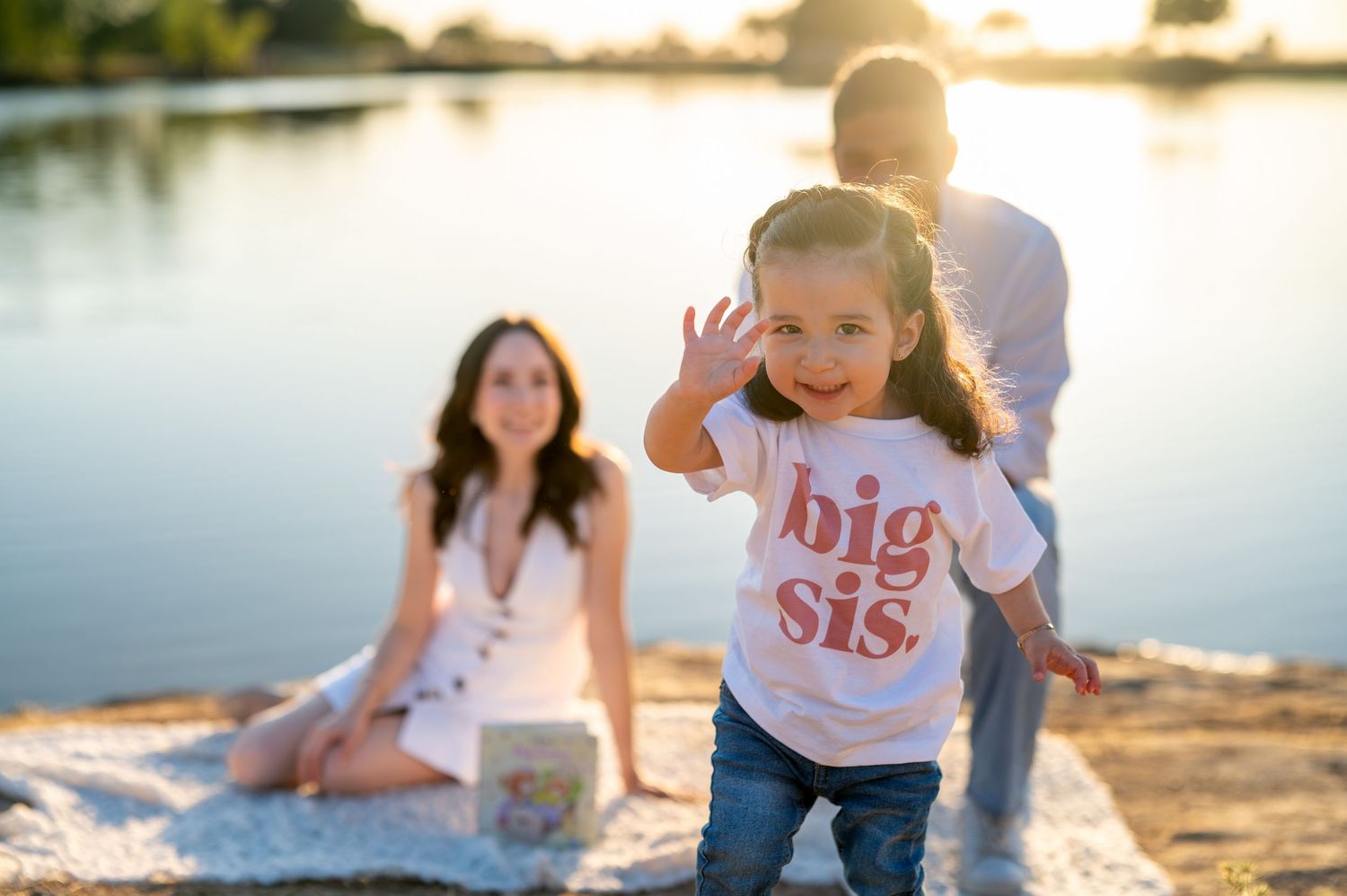 Gibson Ranch pregnancy announcement with big sister. Outdoor maternity family photo session at golden hour