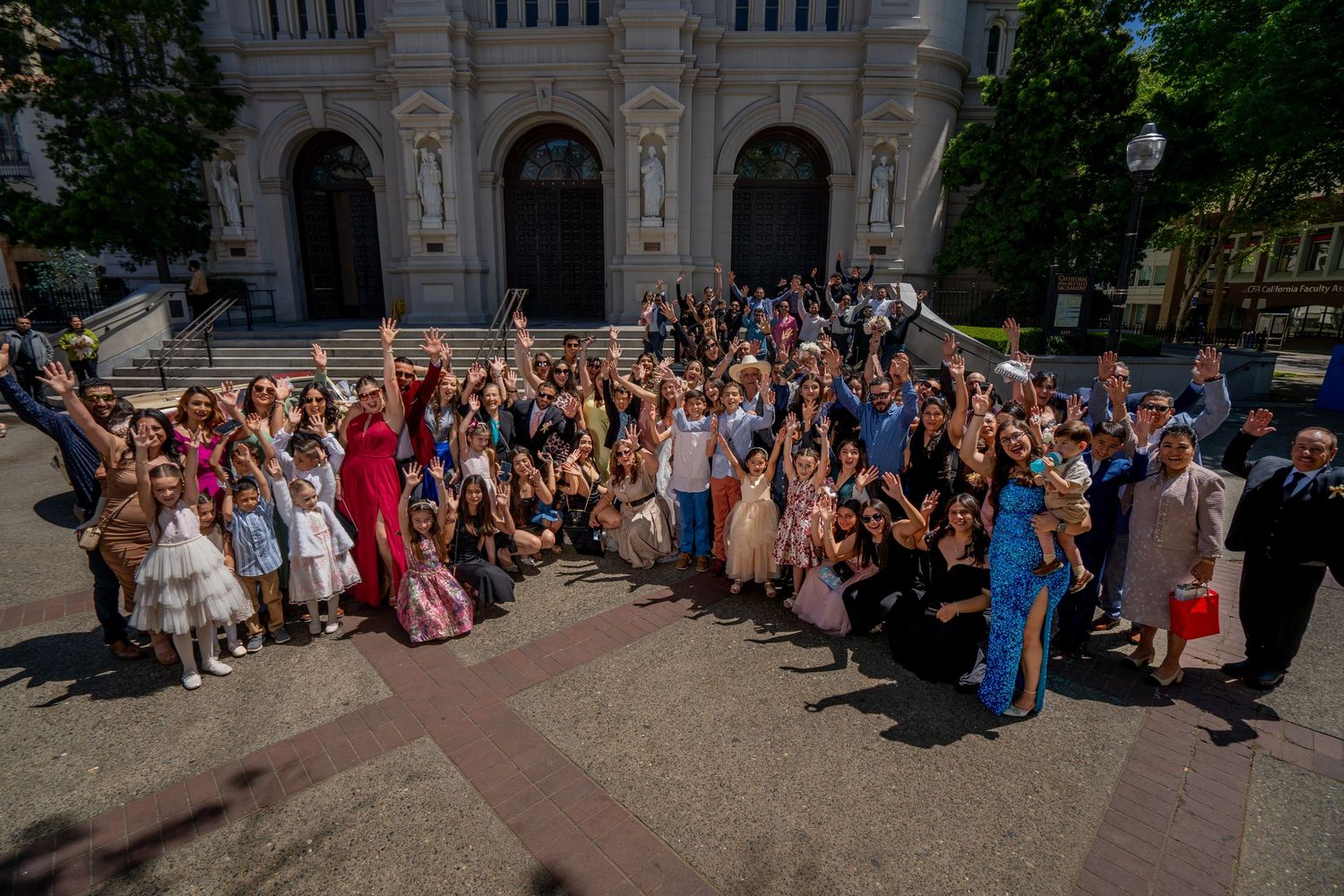 Large wedding group photo outside Cathedral of the Blessed Sacrament Sacramento, Mexican wedding celebration captured by The Padillas.