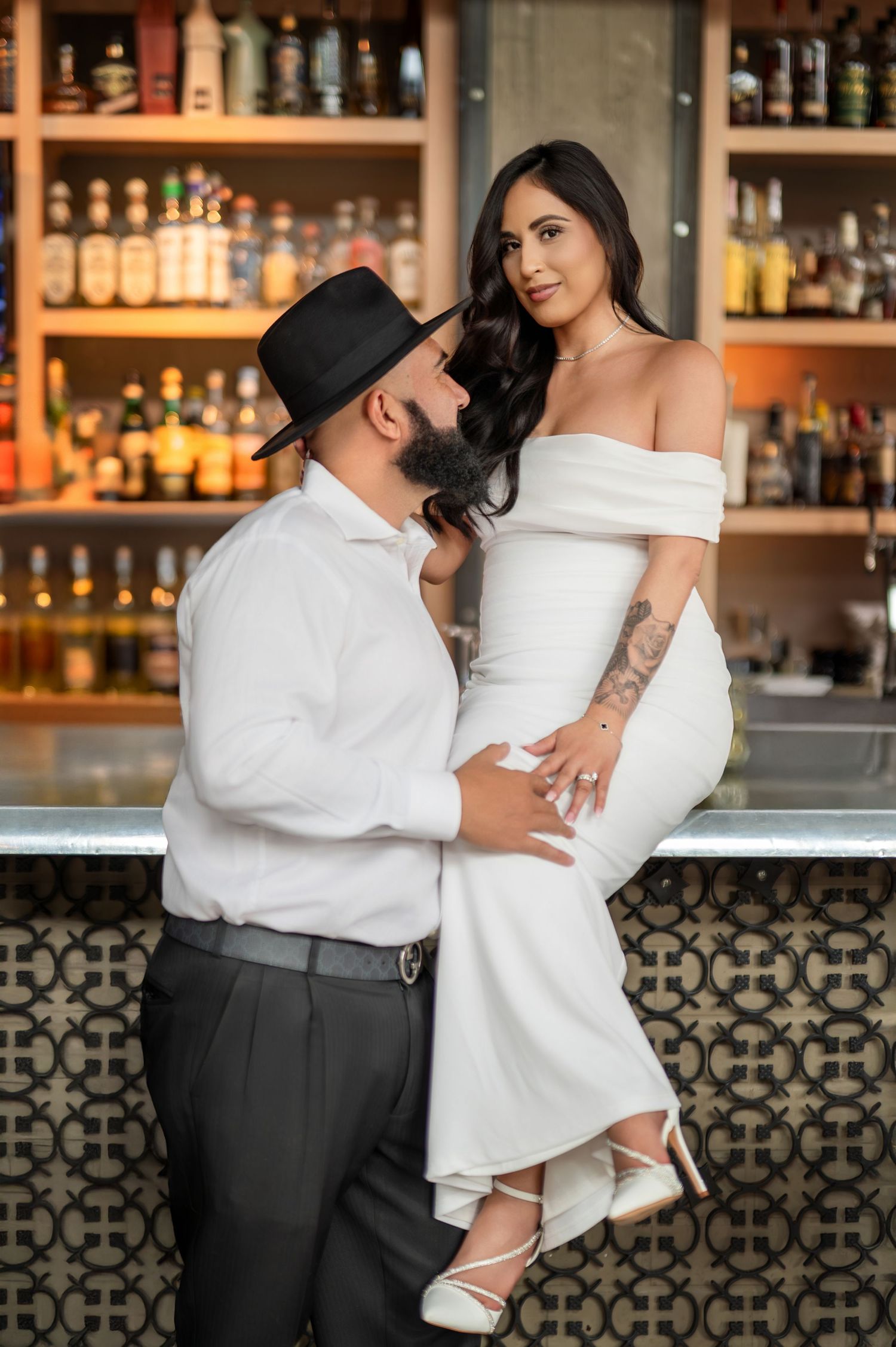 Engagement couple at bar with drinks during downtown Sacramento photoshoot