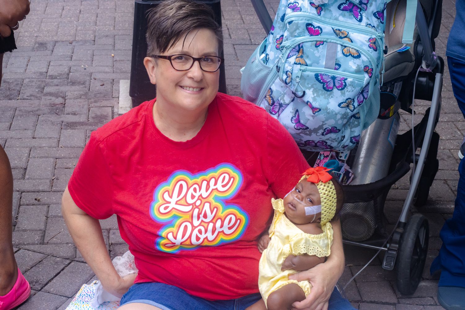 Love is Love - White woman holding black baby