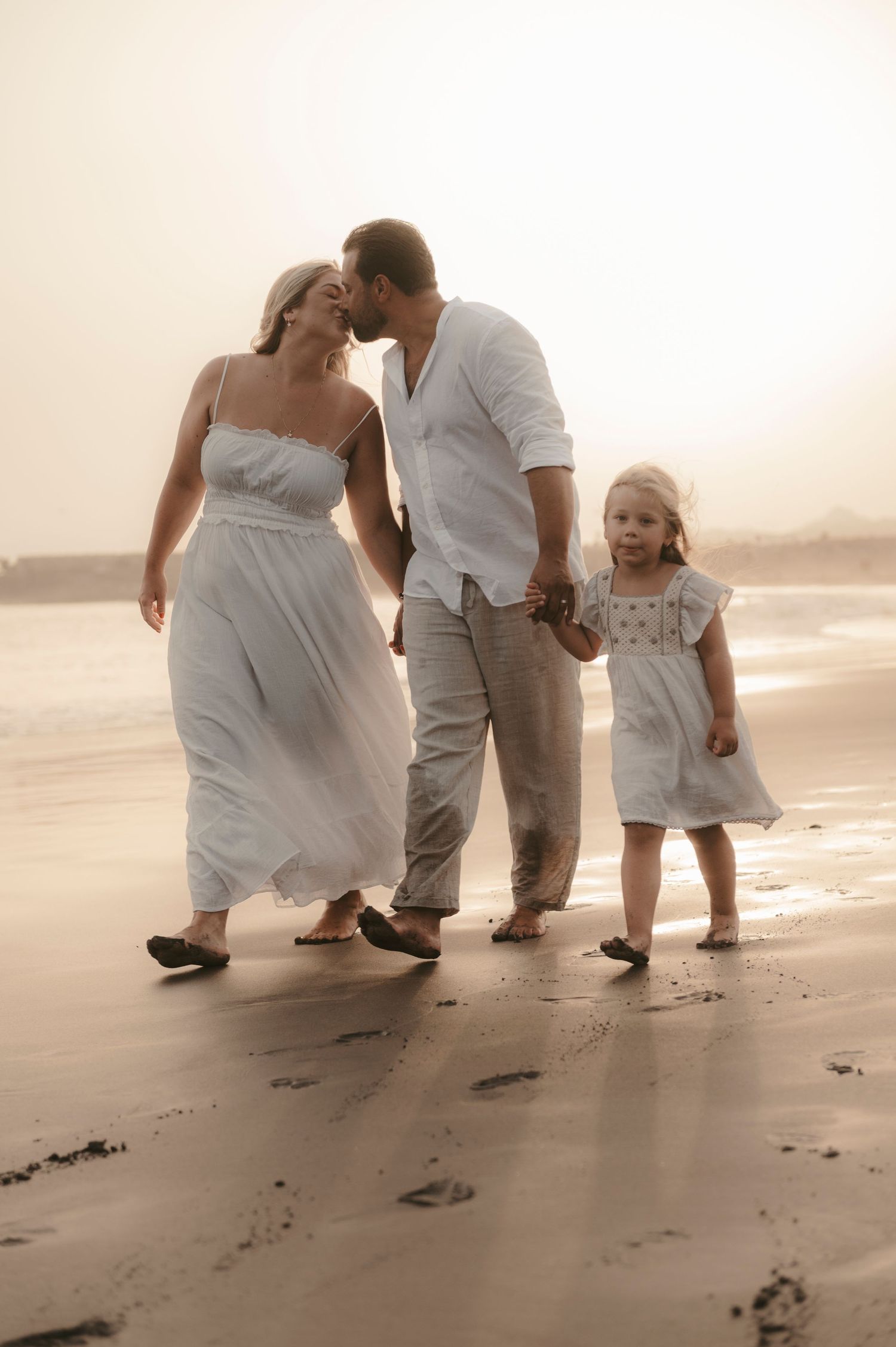 Parents and daughter captured on Playa de la Tejita beach with stunning sand, Tenerife