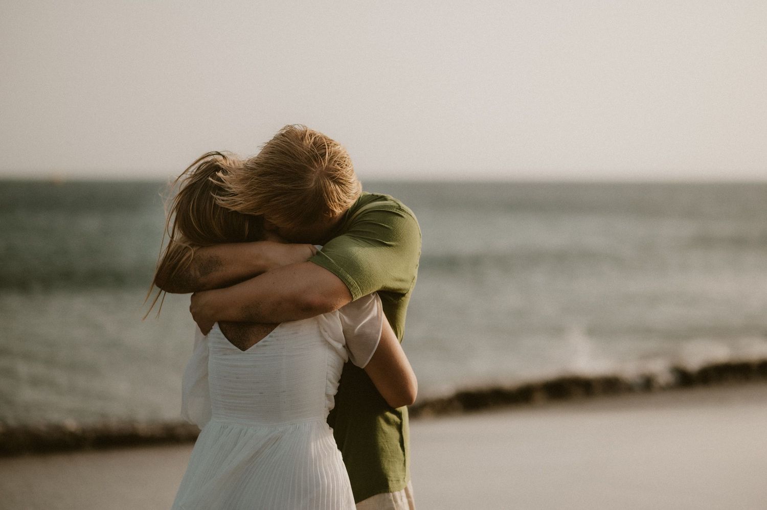 Close-up of a young couple embracing lovingly on Playa Tejita, barefoot in the sand near the ocean, Tenerife couples photoshoot