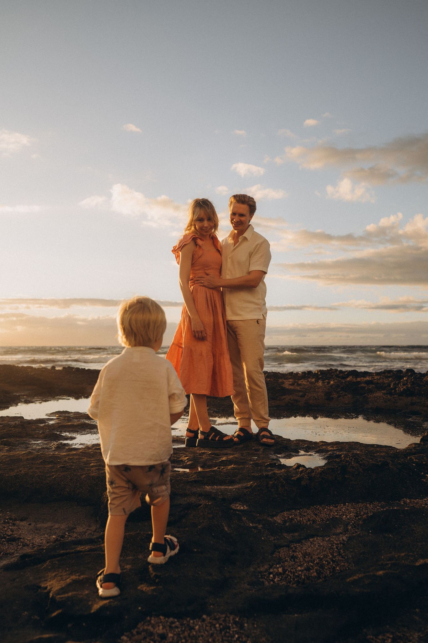 Family photoshoot with parents and 2-year-old son by ocean and cliffs, Las Americas