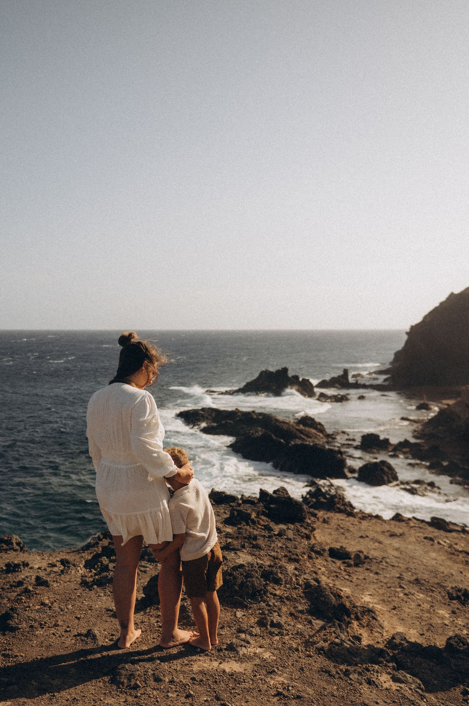 Family moment with mother and child gazing at Atlantic Ocean, Montaña Roja