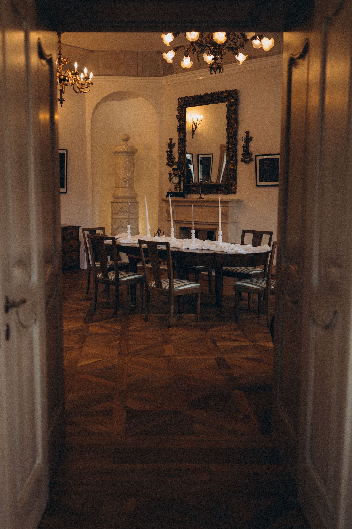 Elegant wedding reception hall beautifully styled with tables and décor, viewed through the entrance doors.