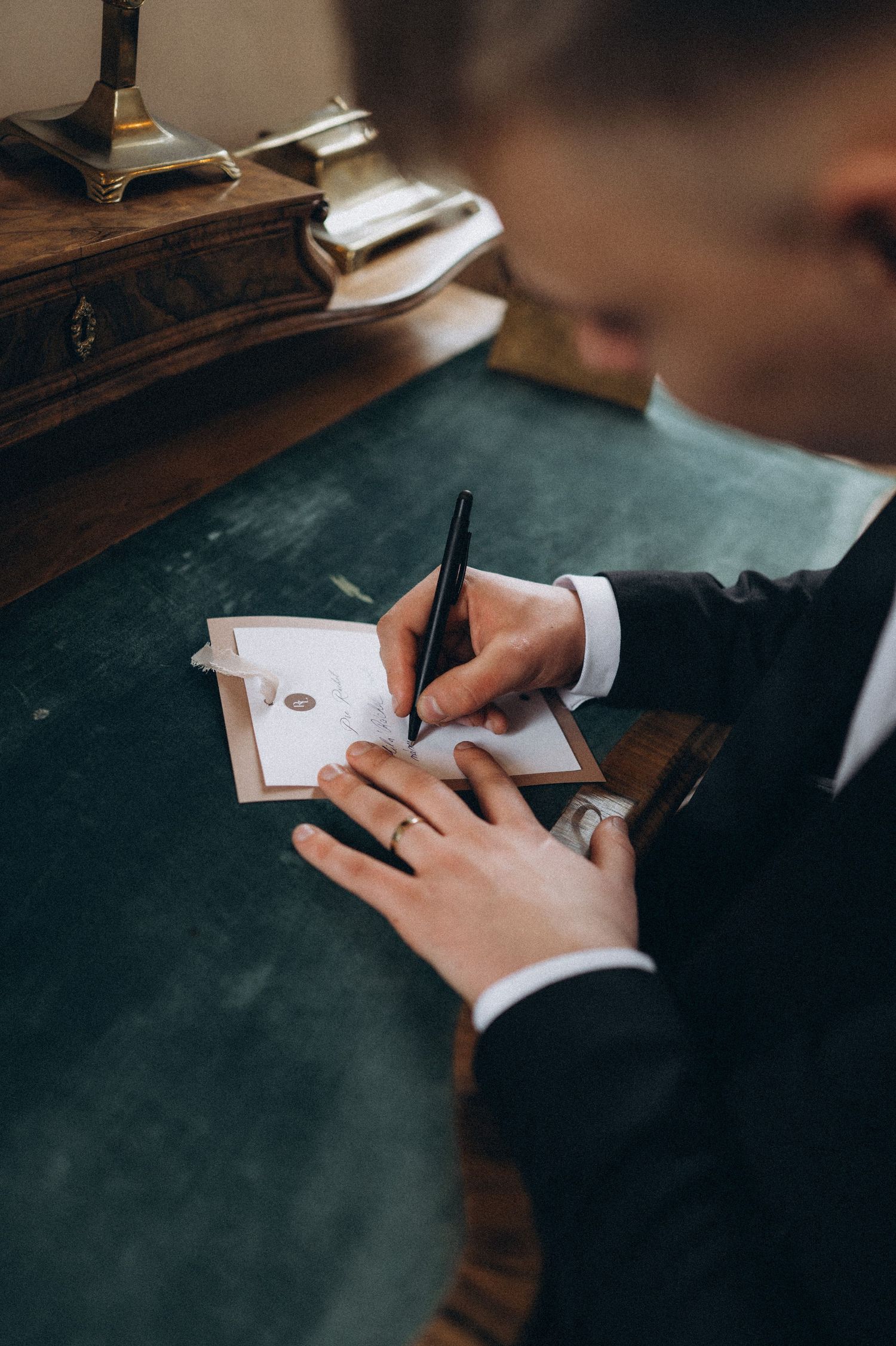 Groom writing his wedding vows during an emotional moment on his wedding day.