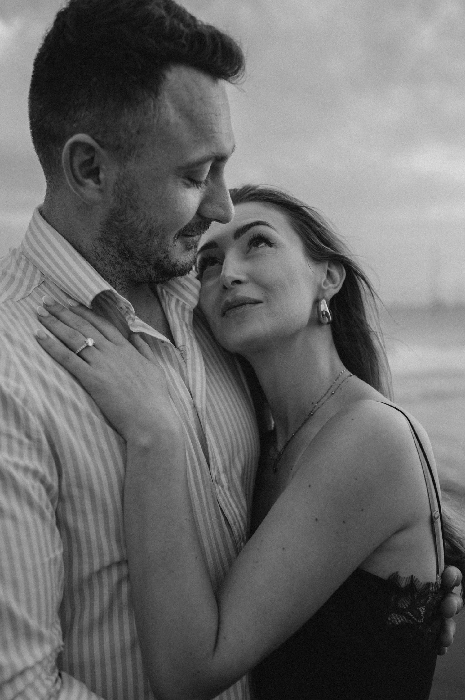 Romantic couple in hug overlooking Playa de La Tejita and Montaña Roja, Tenerife