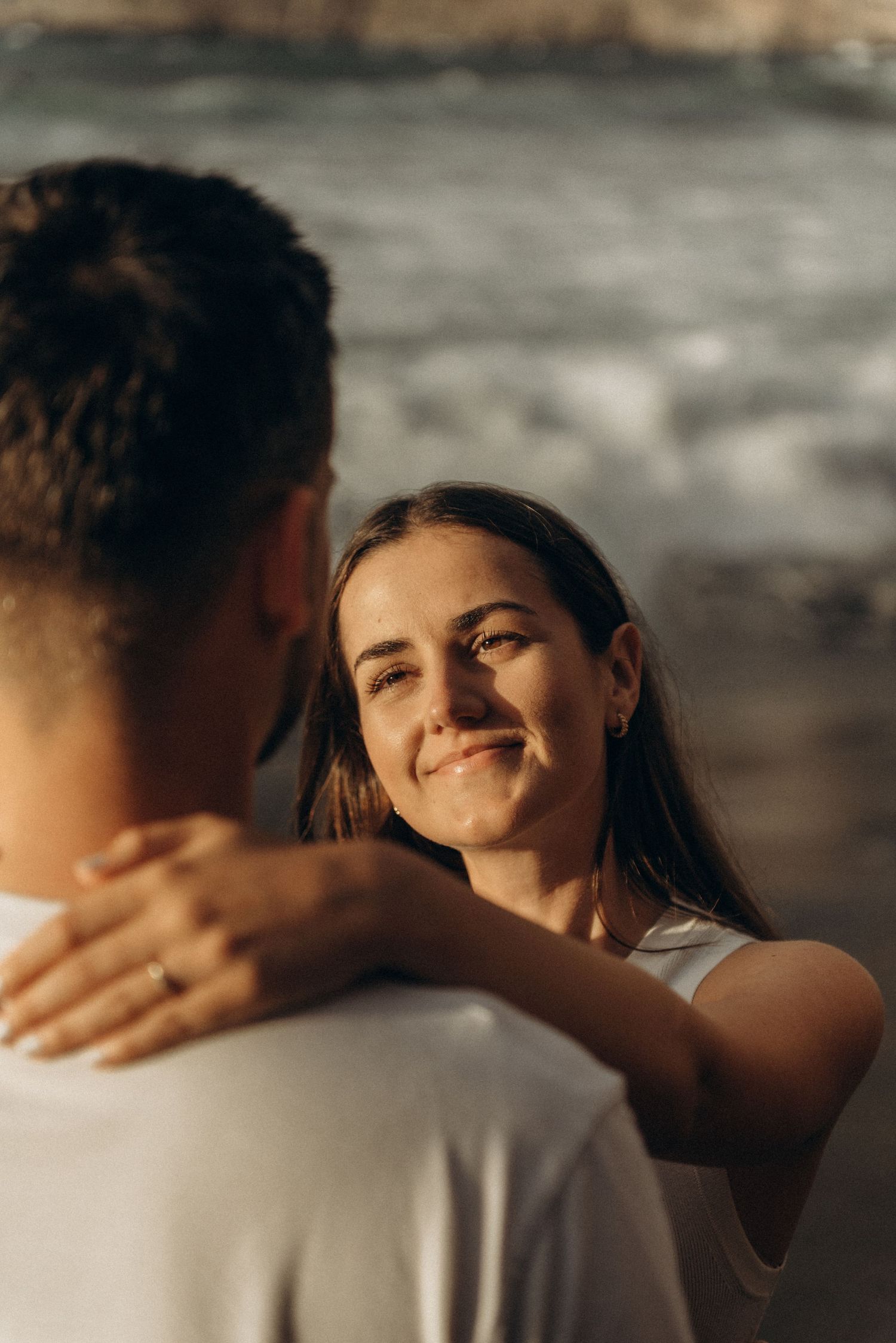 Close-up of engagement ring as woman’s hand is kissed on Playa de Los Guíos, Tenerife