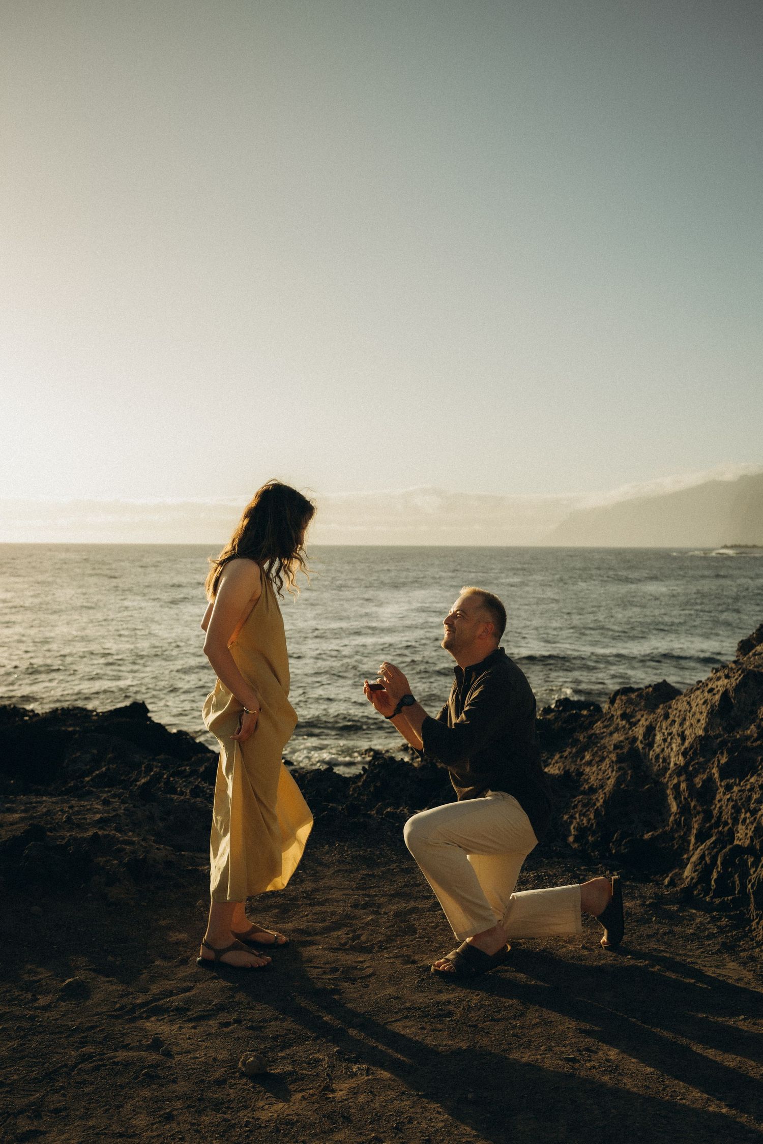 Surprise proposal in Los Gigantes and Alcalá, Tenerife at sunset with dramatic coastal scenery and ocean waves in the background.