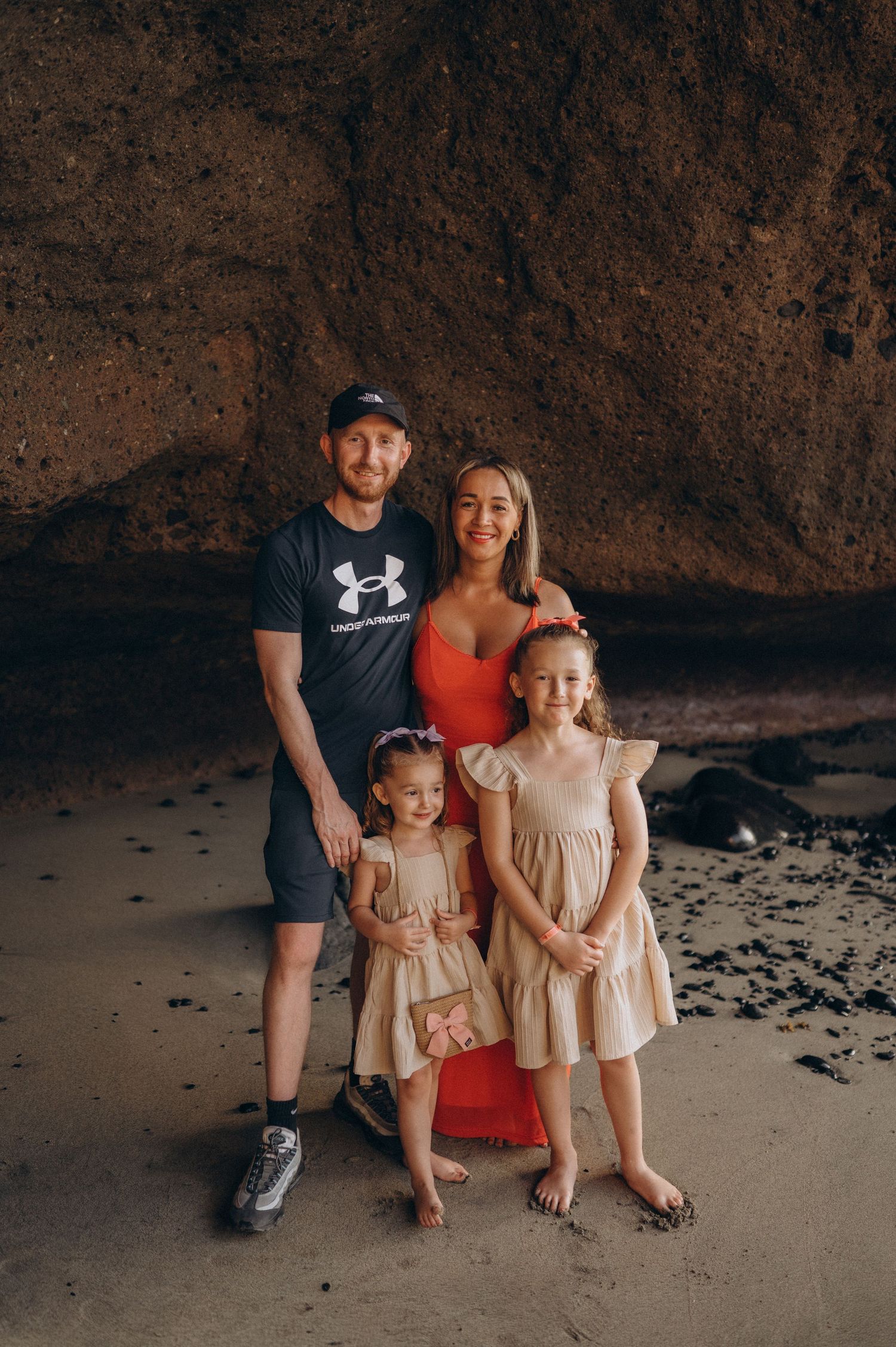 Family photoshoot by the ocean under cliffs at Playa Morteros beach, Tenerife
